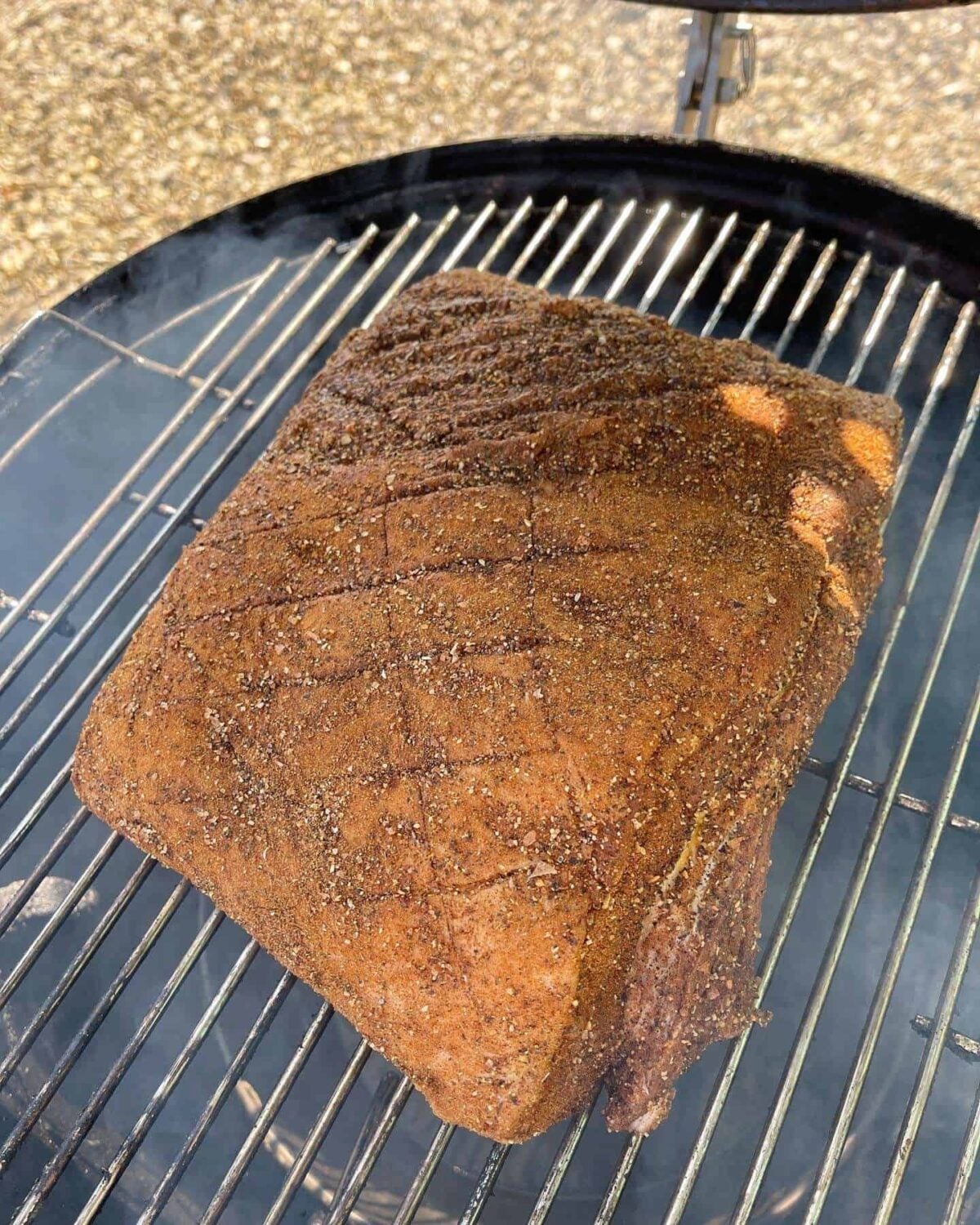 whole pork belly cooking on BBQ
