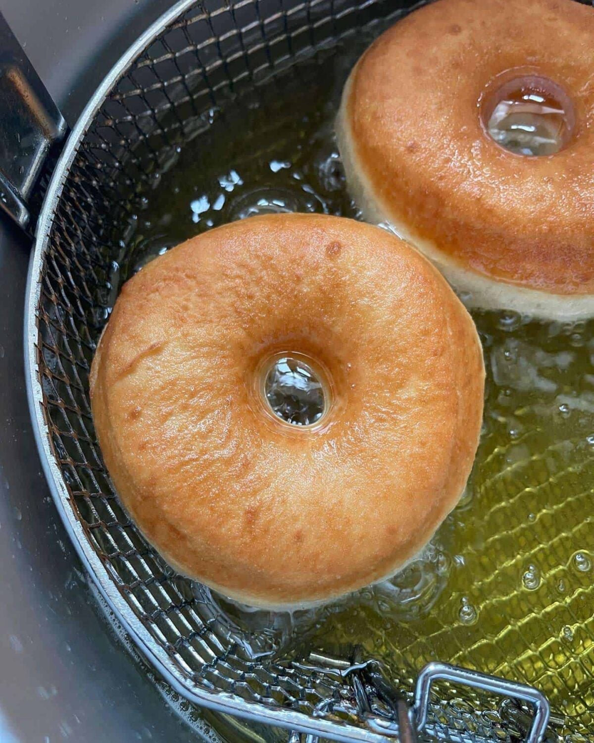ring doughnuts frying in hot oil