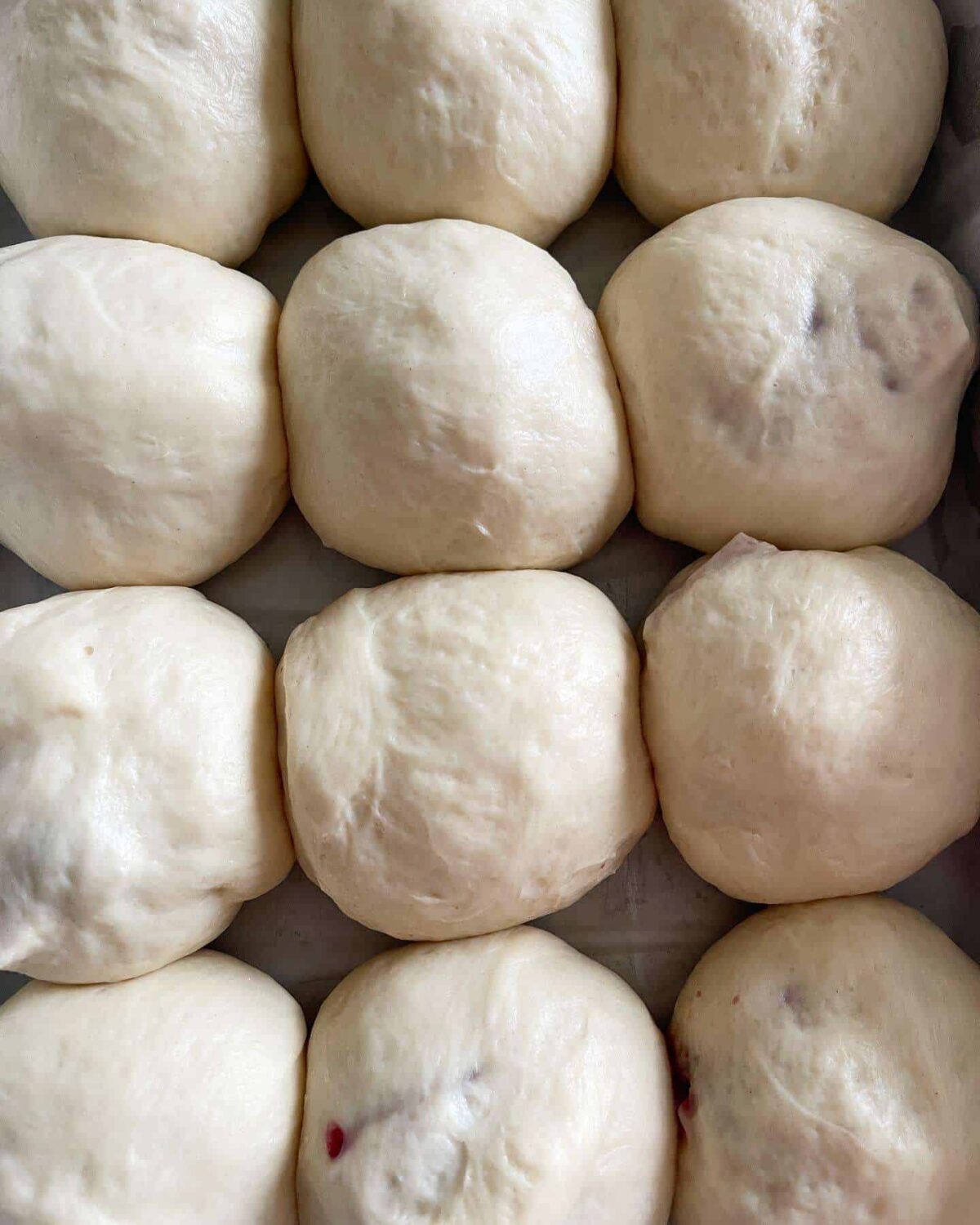 proved dough balls in lined baking tin