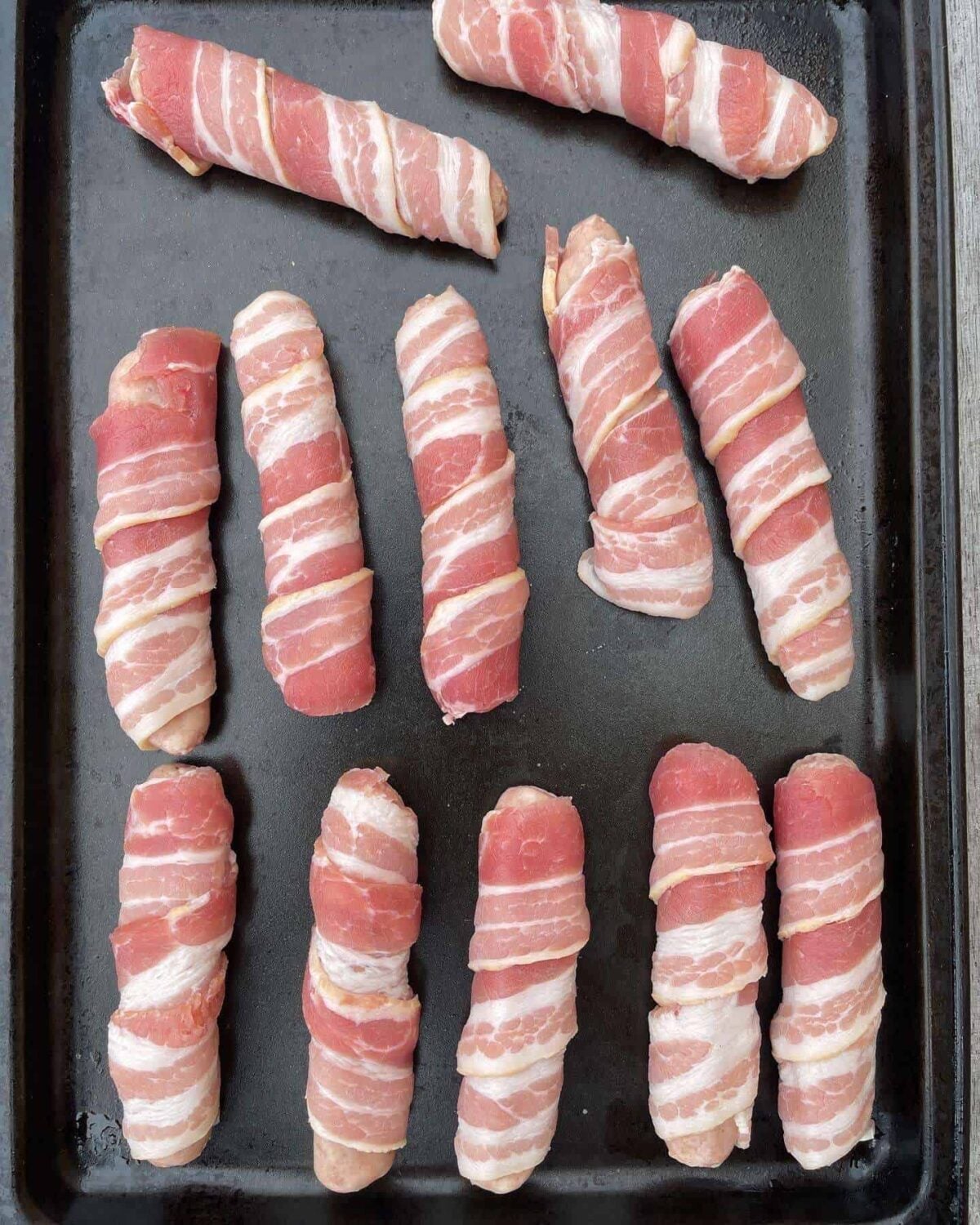 chipolata sausages wrapped in streaky bacon
