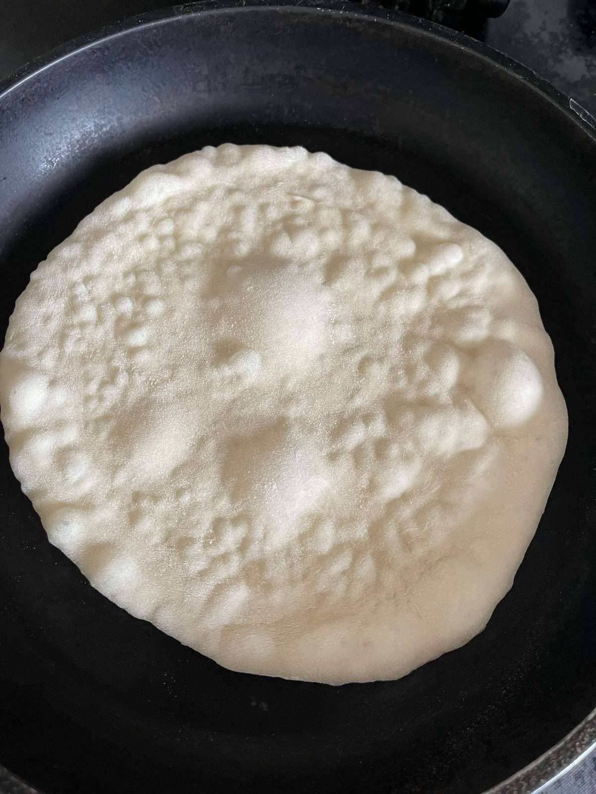 dough cooking in a frying pan