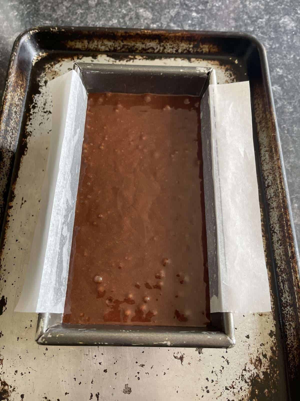 chocolate cake batter in loaf tin