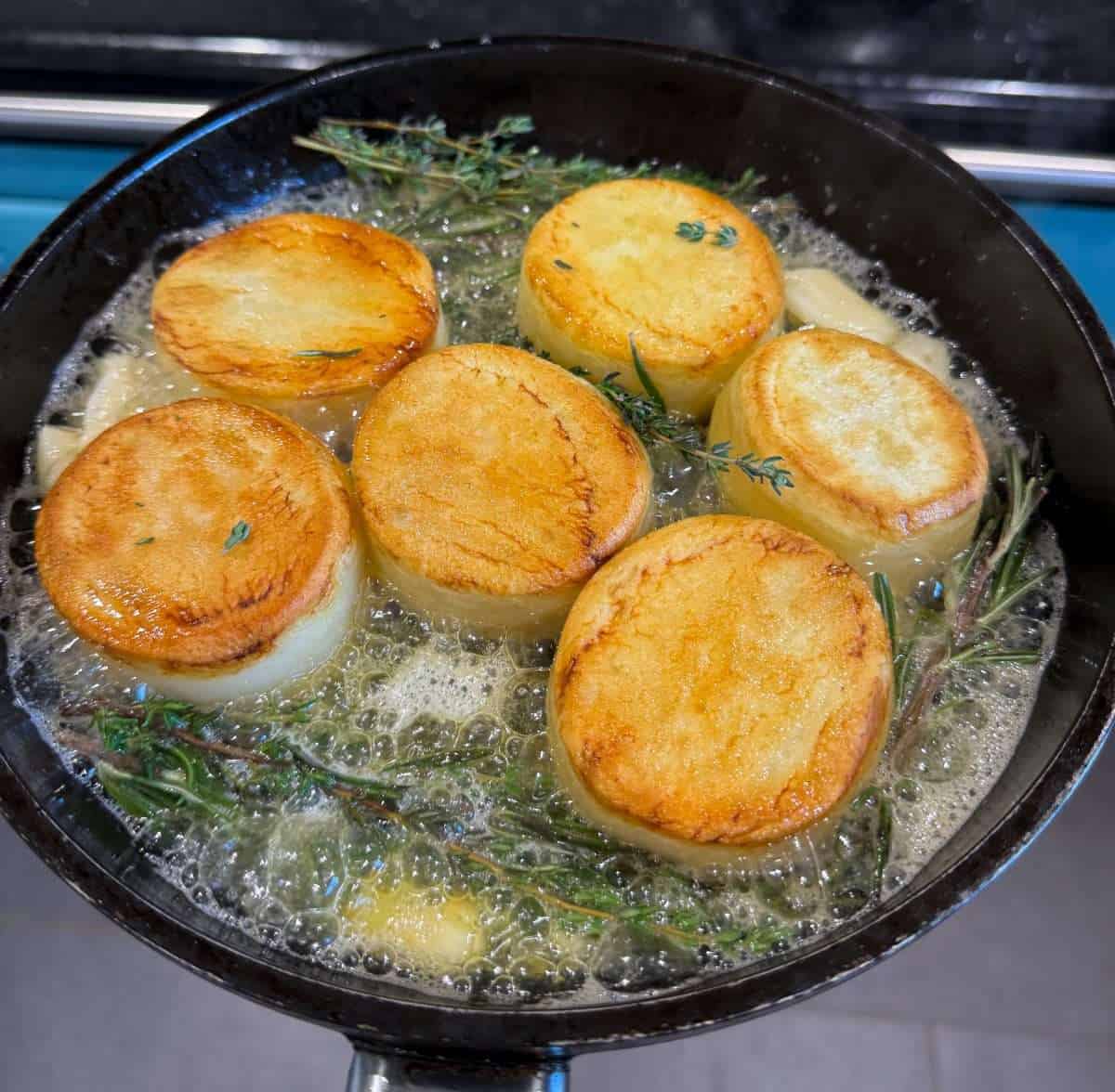 potatoes cooking in stock & butter
