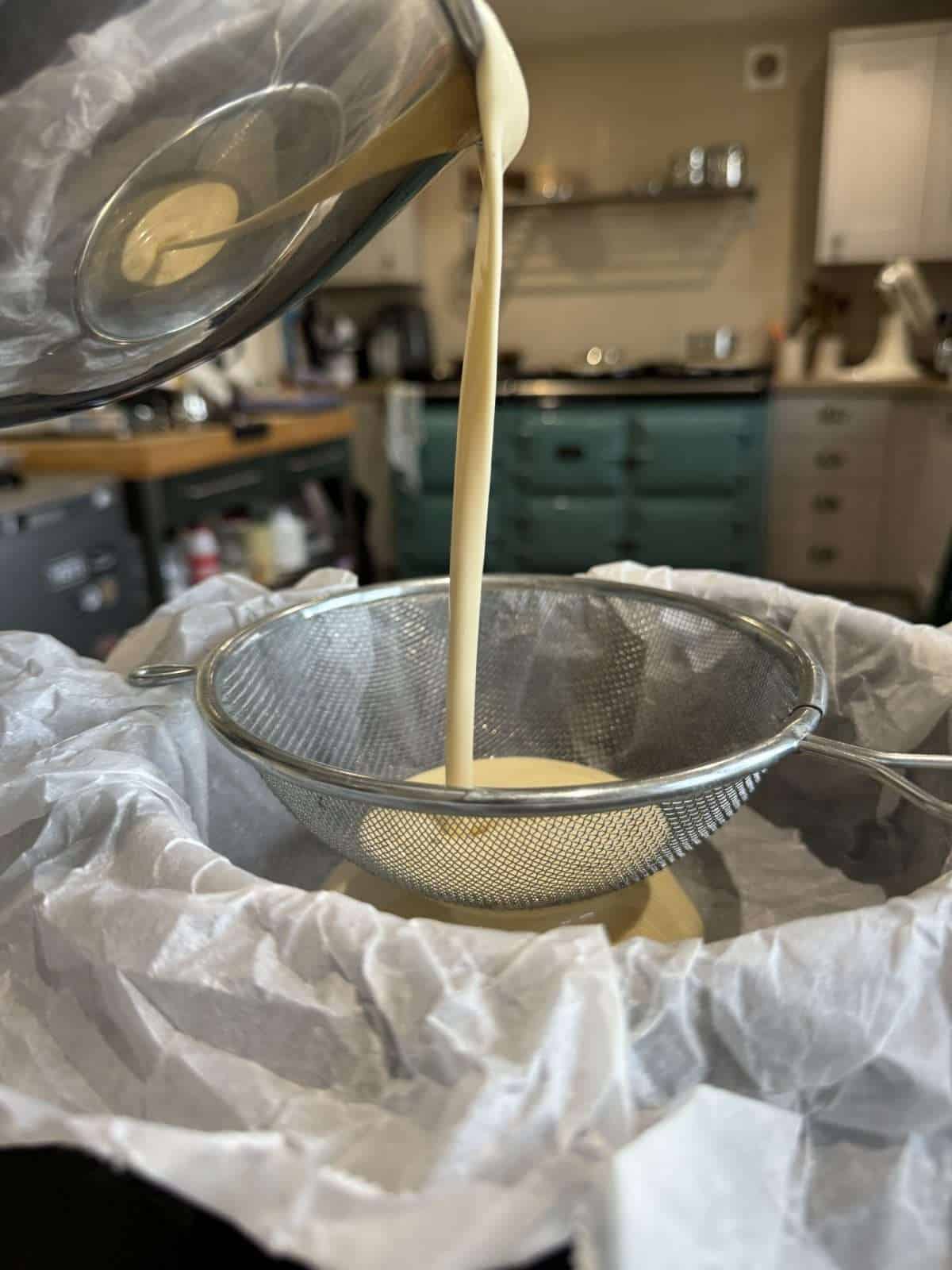 passing cheesecake batter through sieve