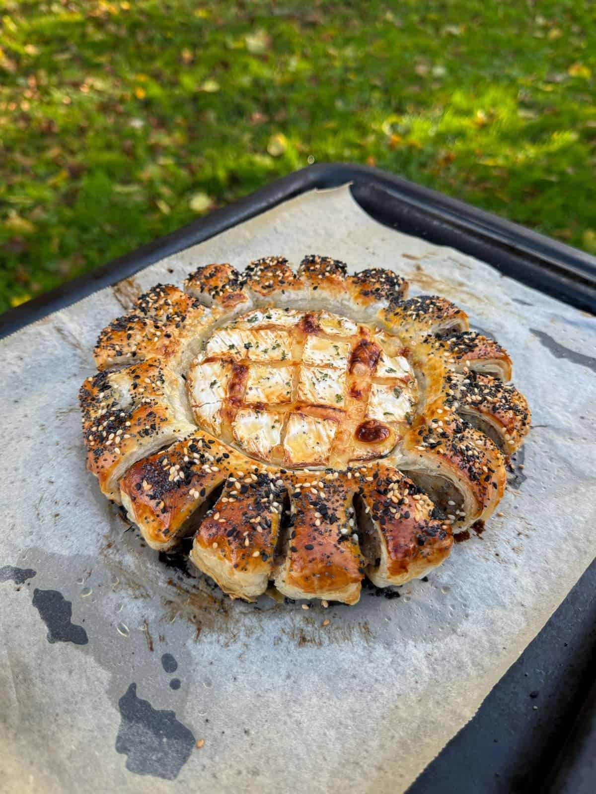 sausage roll wreath with baked camembert