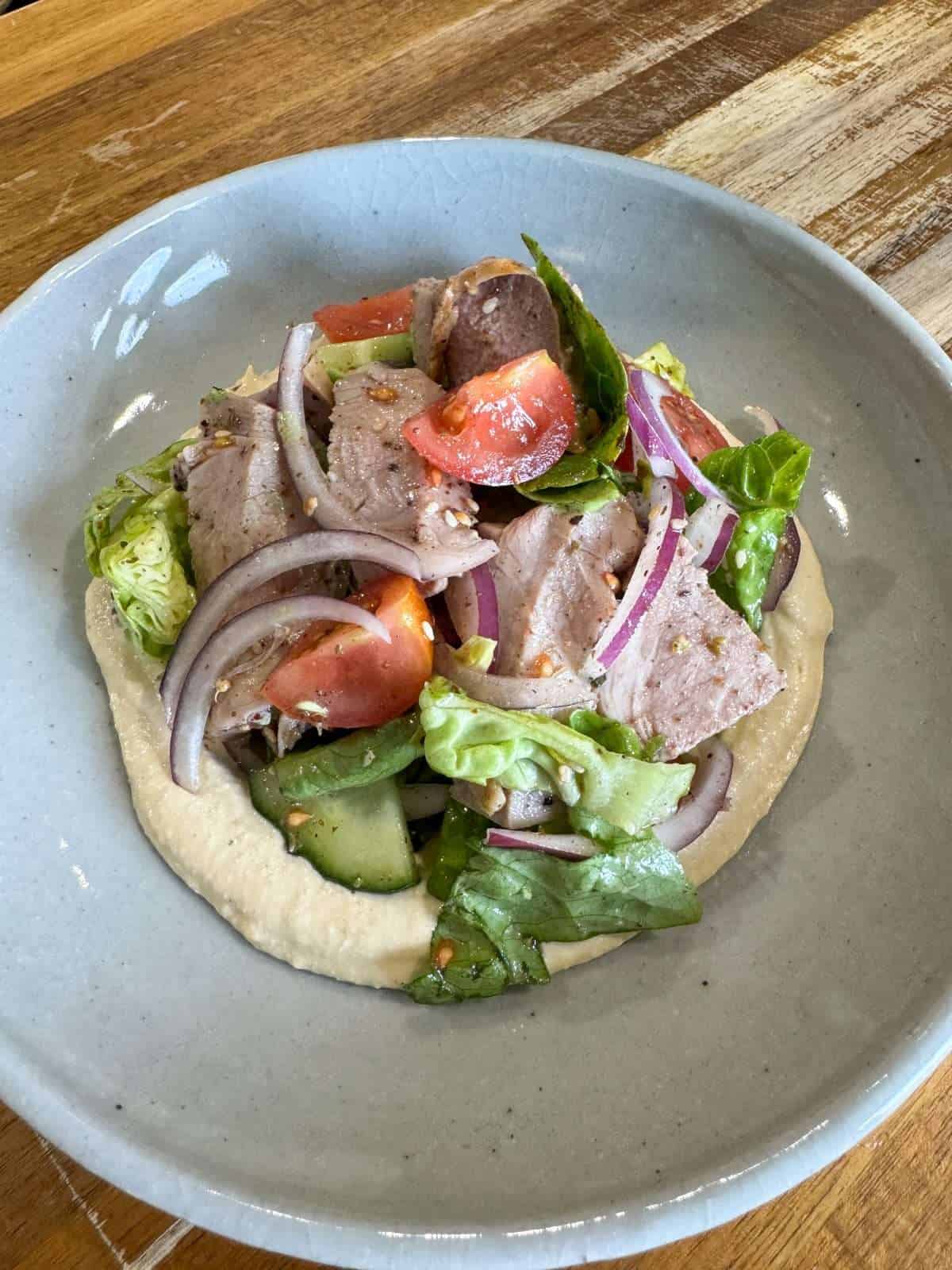 hummus topped with salad