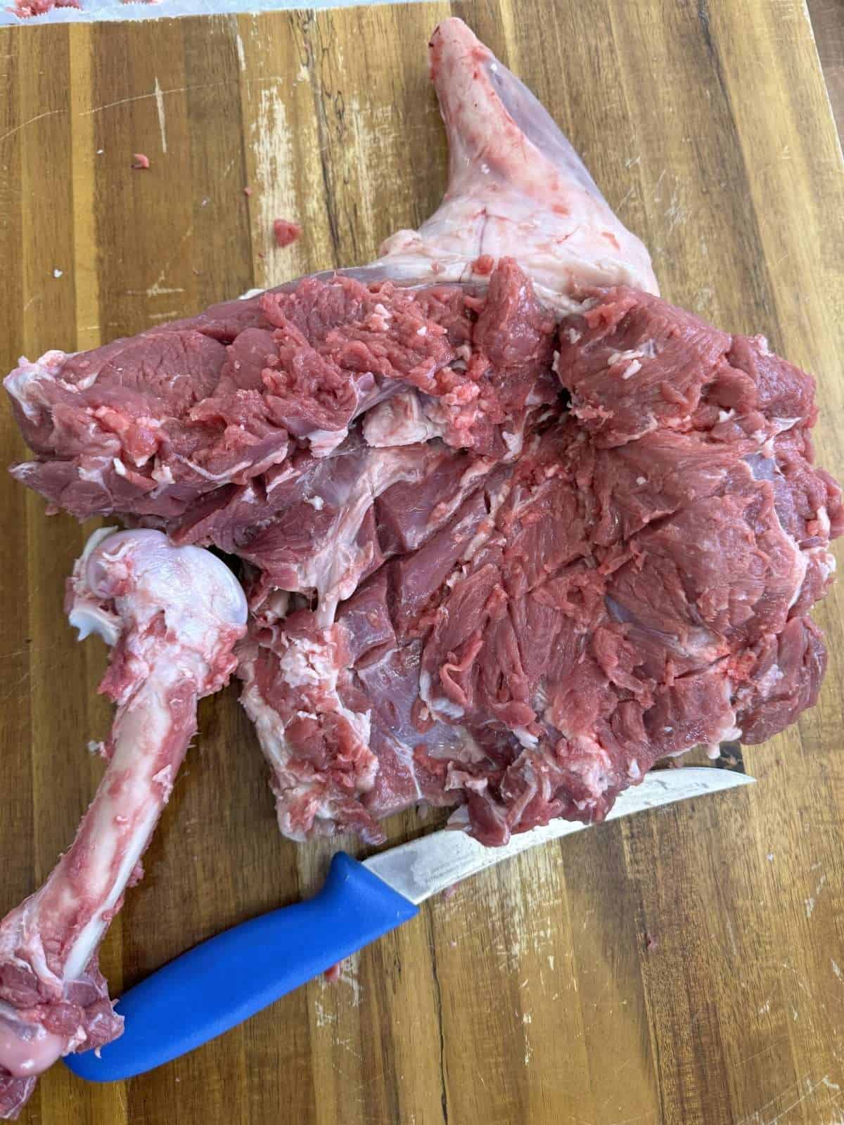 removing the leg bone from lamb