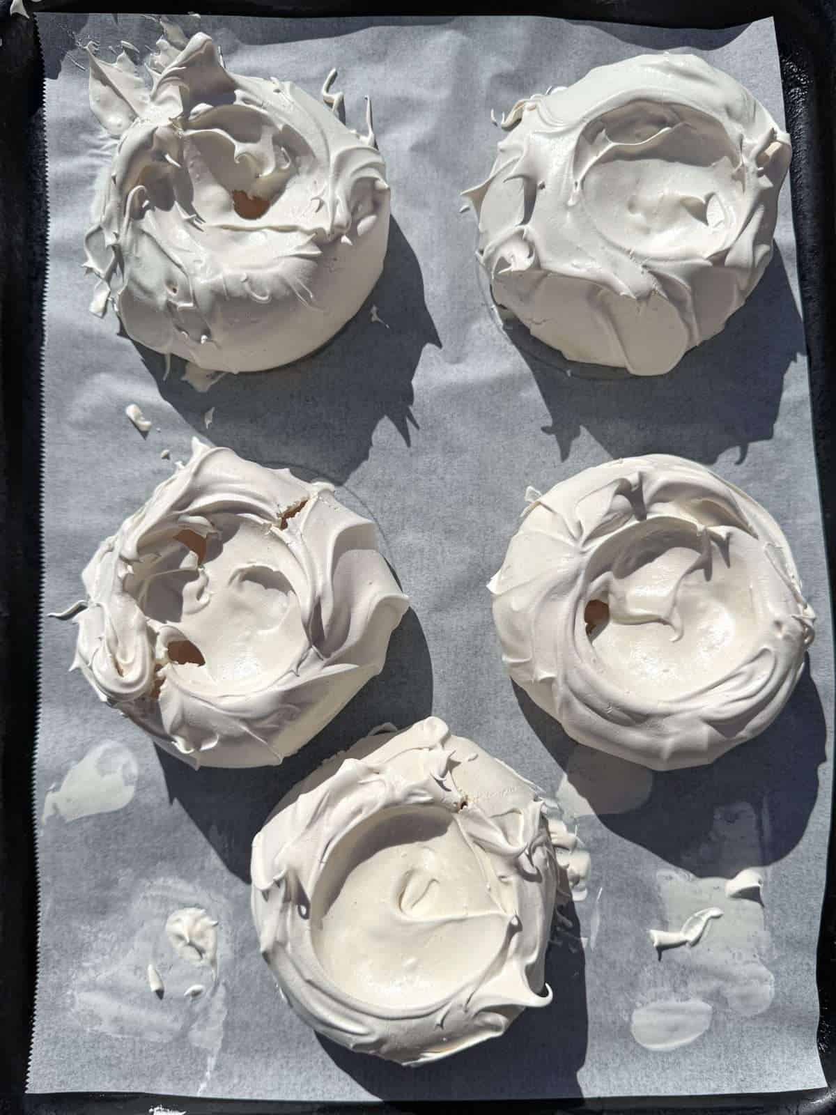 baked individual pavlovas ready for topping