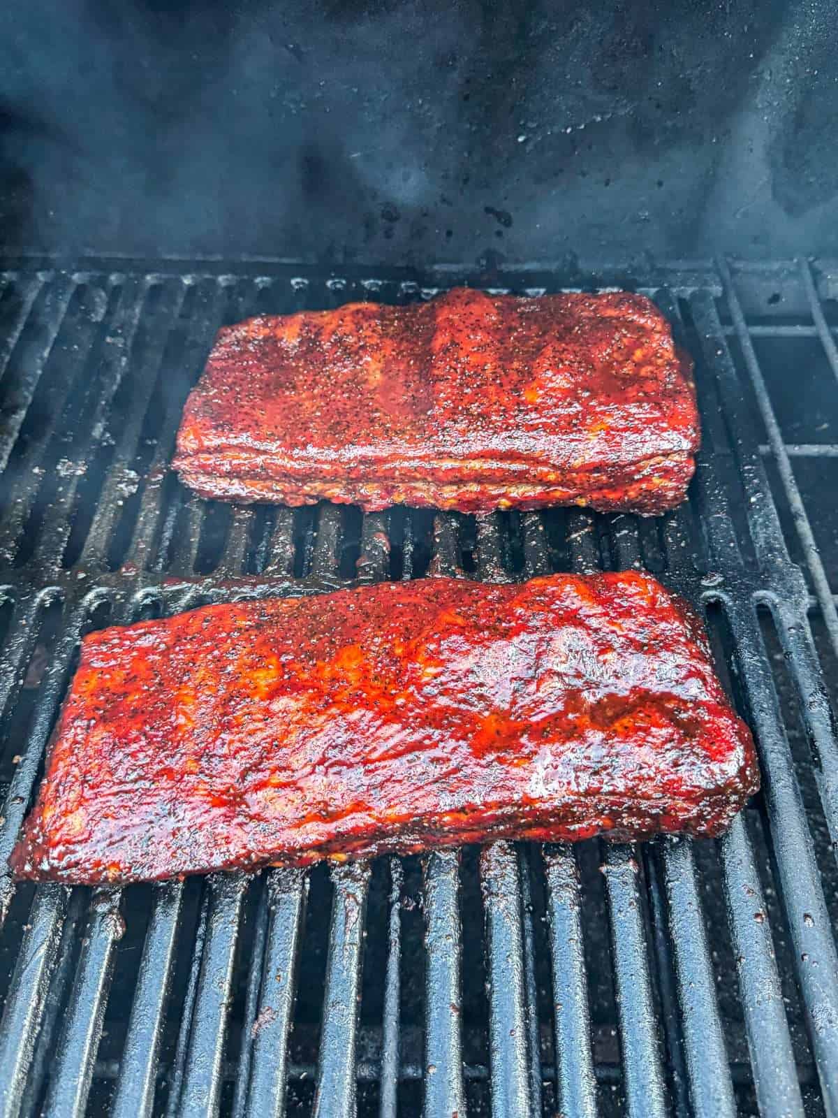 smoked spare ribs brushed with barbecue sauce