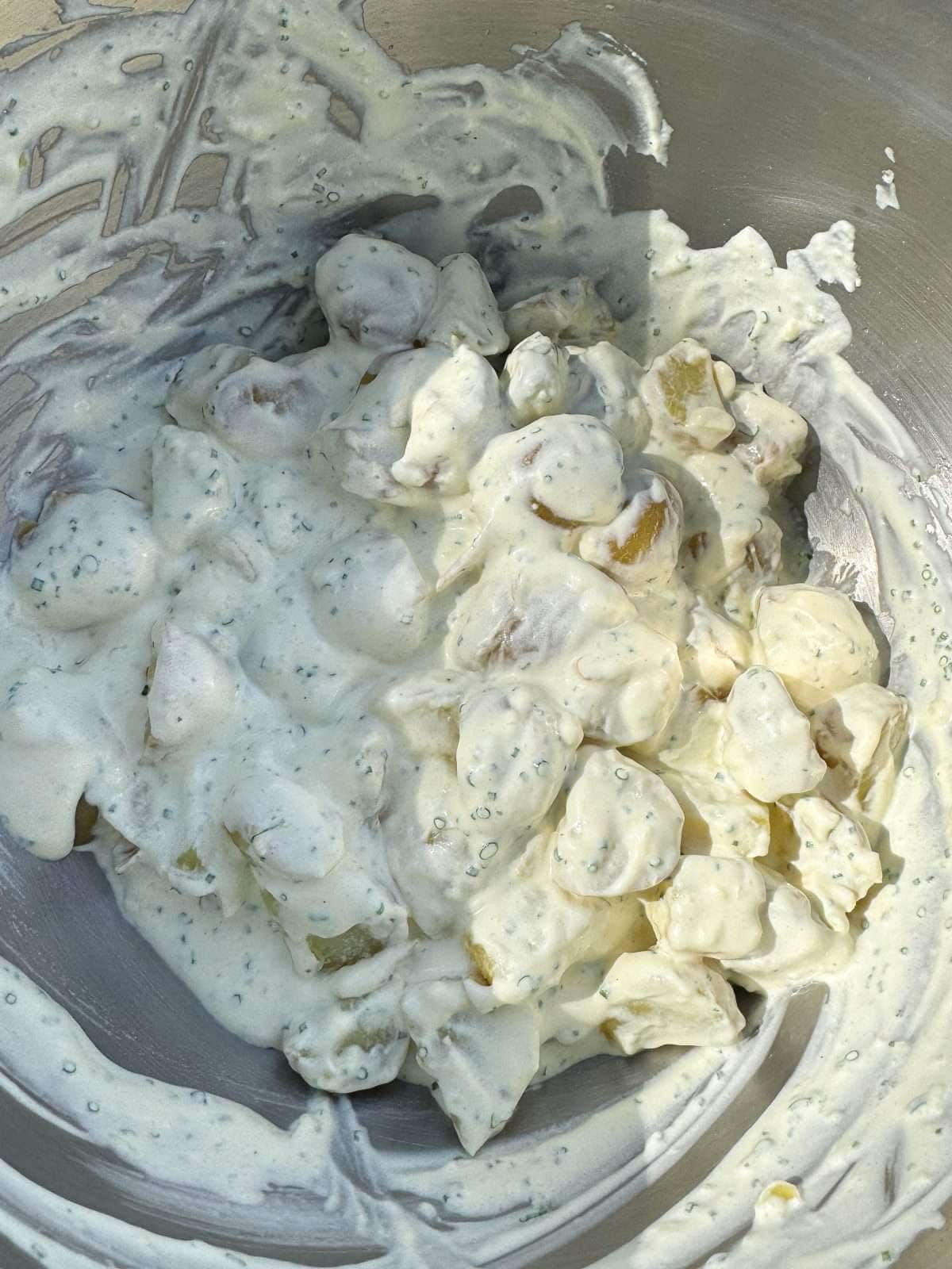 sour cream & chive potato salad in mixing bowl