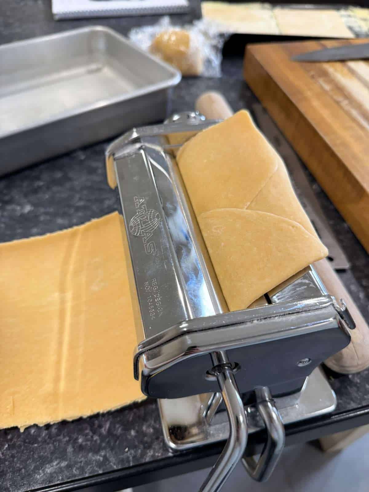 rolling out pasta with machine