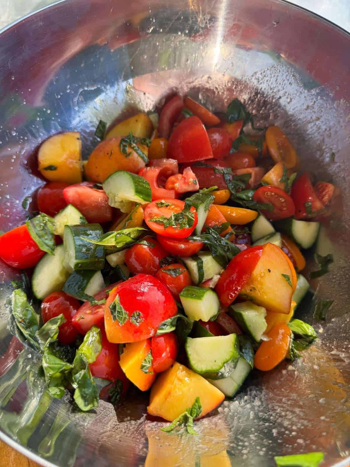 dressed tomato salad in mixing bowl