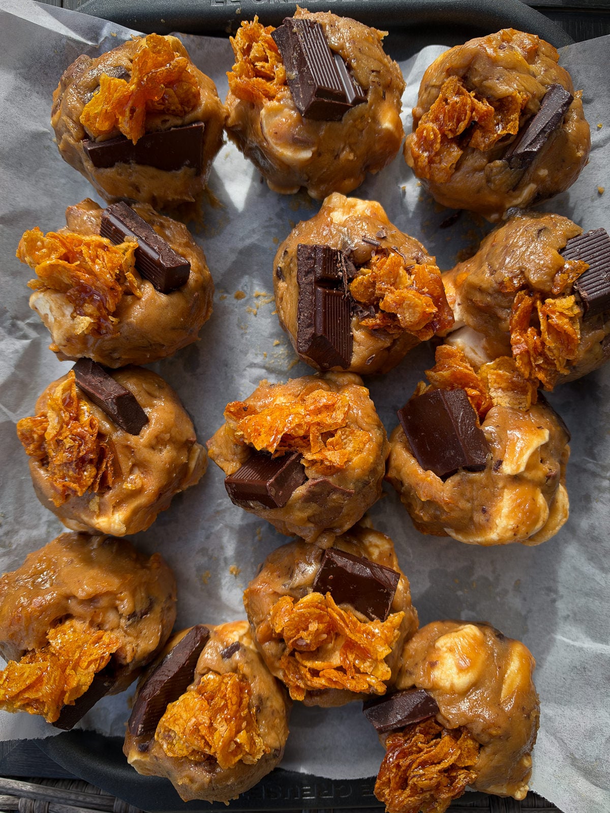 balls of cookie dough with chocolate chunks on top