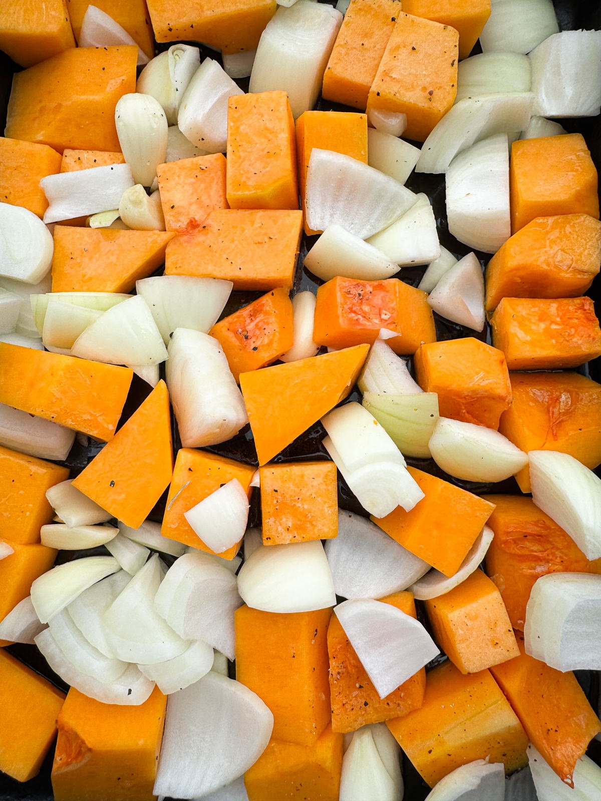 chopped pumpkin onion garlic for roasting