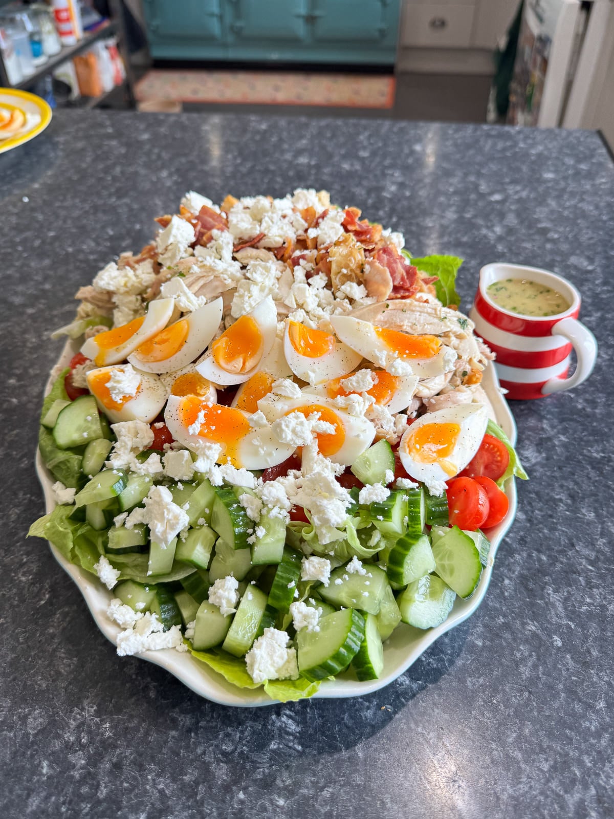 chicken cobb salad platter with jug of dressing