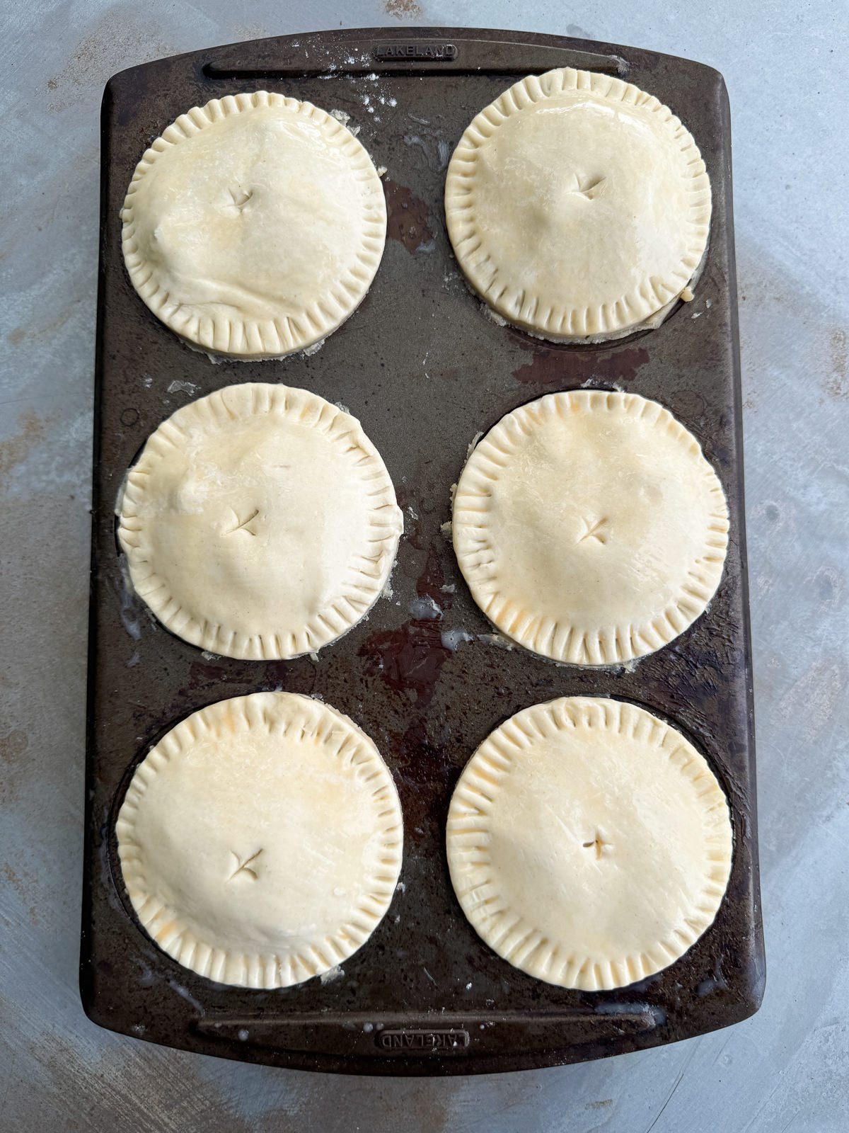 egg washed pies in tin