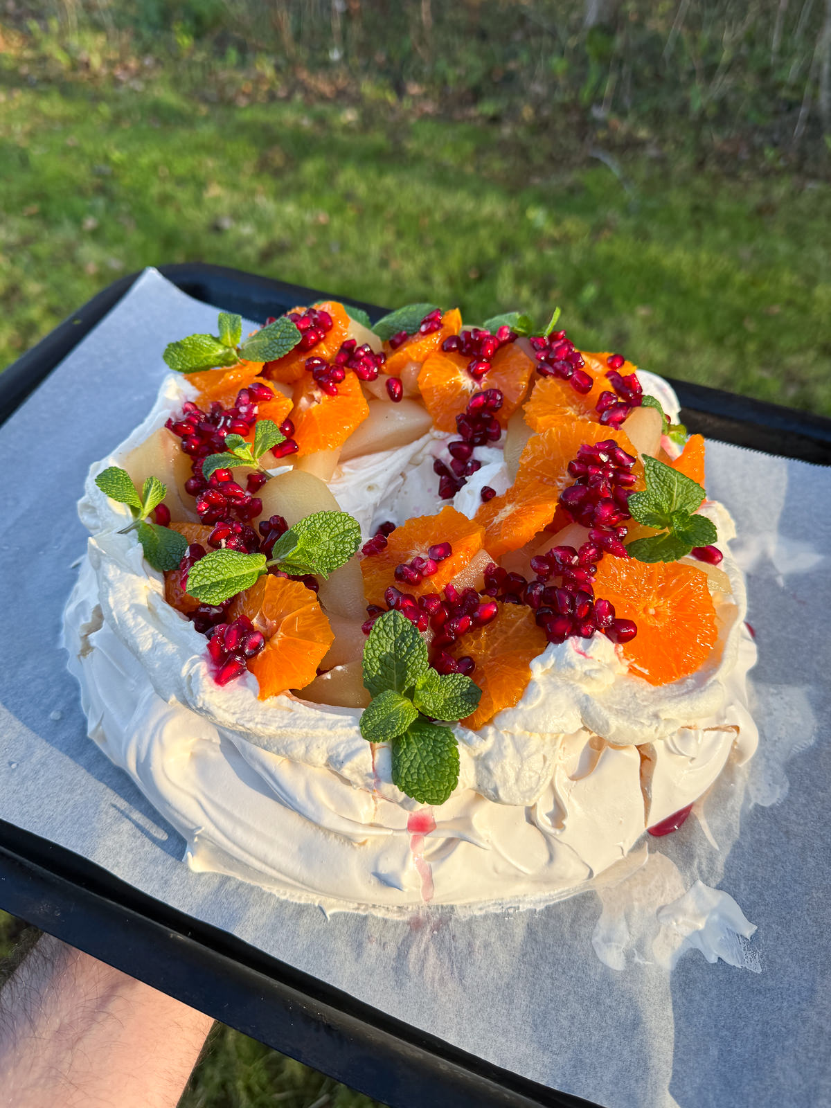 pavlova wreath topped with cream & fruit