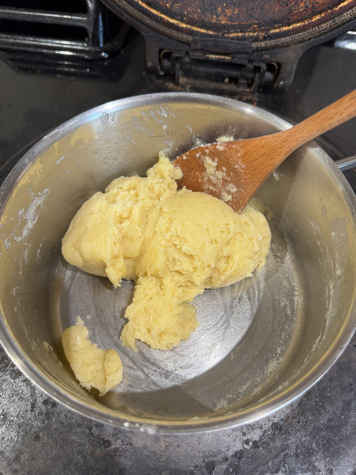 floured stirred into milk with wooden spoon