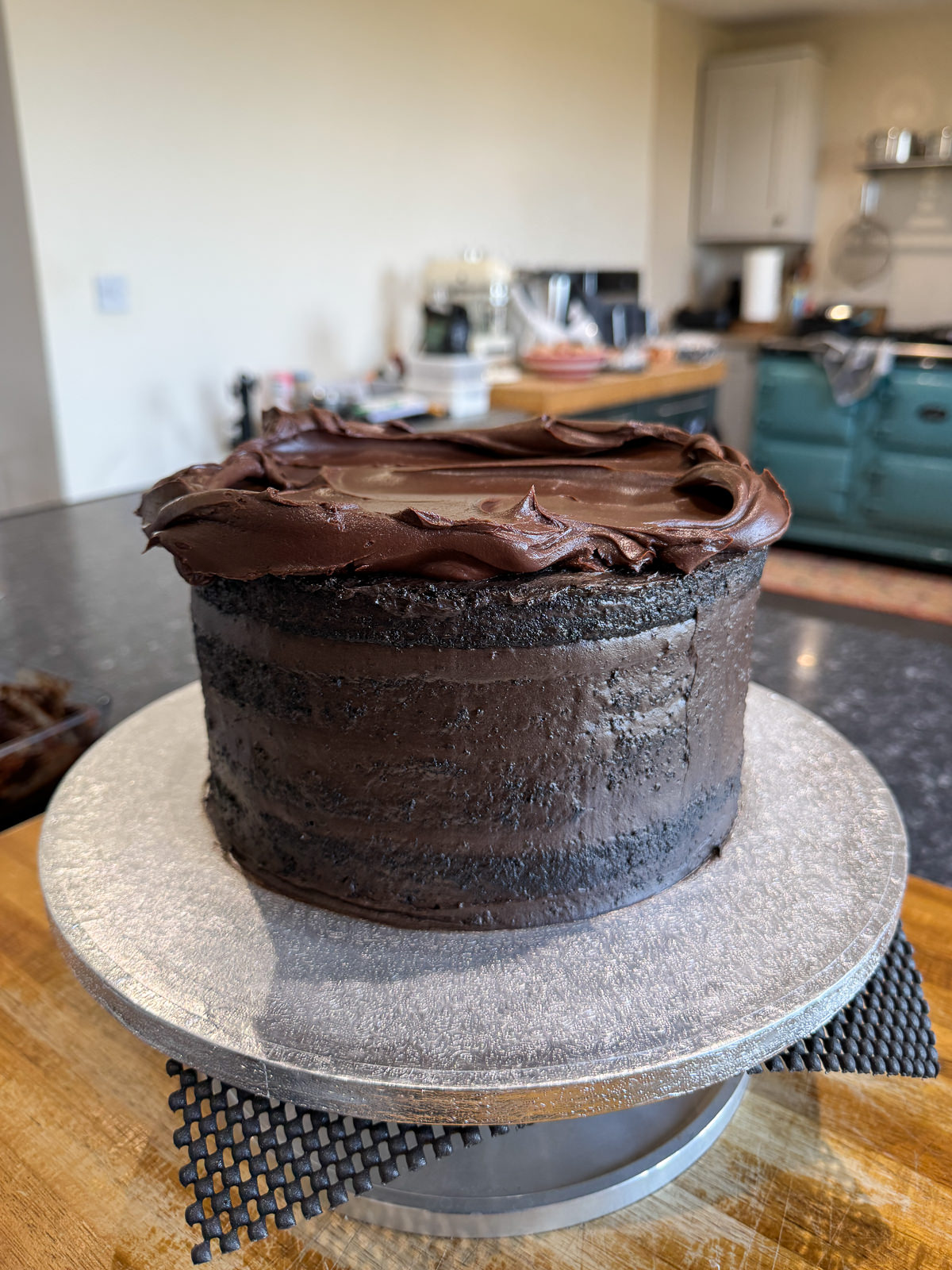 spreading ganache onto layer cake