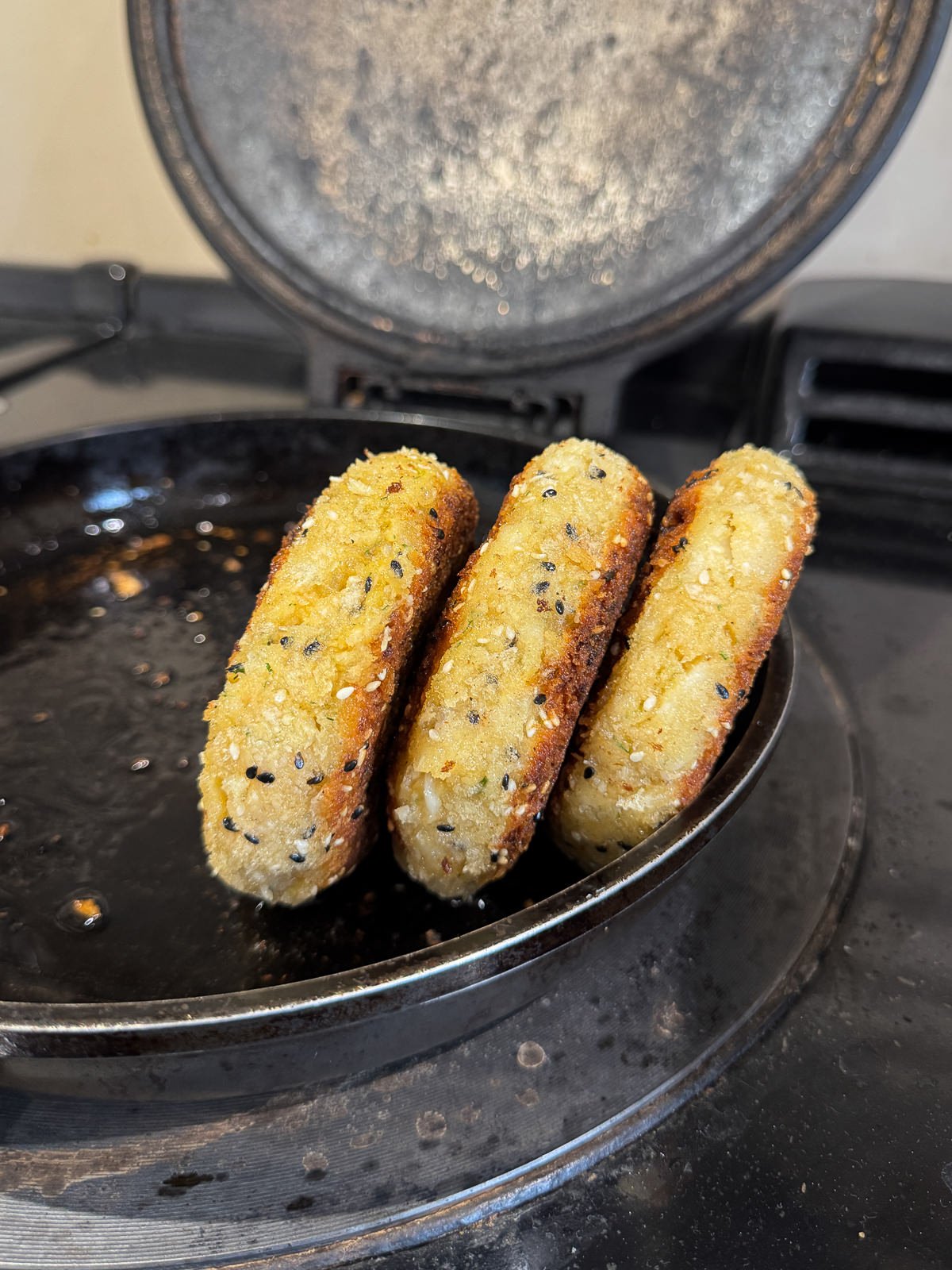 frying sides of fish cakes to crisp up all over