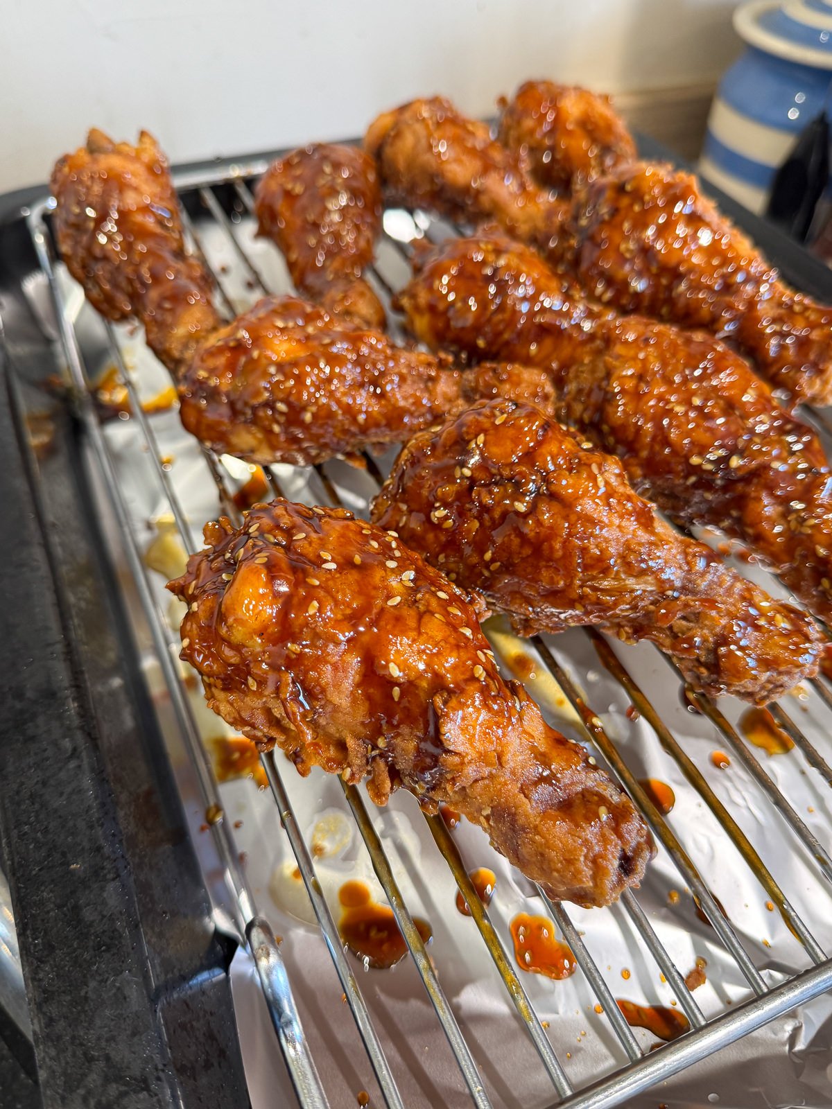 hoisin honey glazed fried chicken drumsticks with sesame seeds
