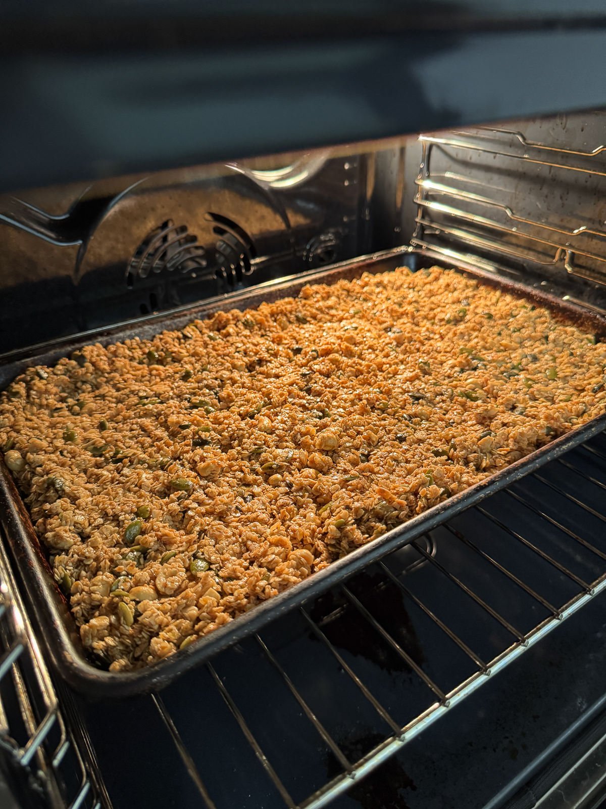 granola baking in oven on tray