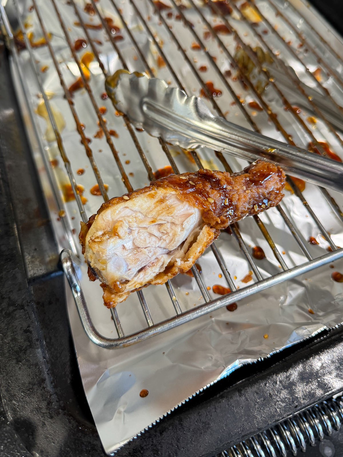 inside of fried chicken drumstick to show juicy meat