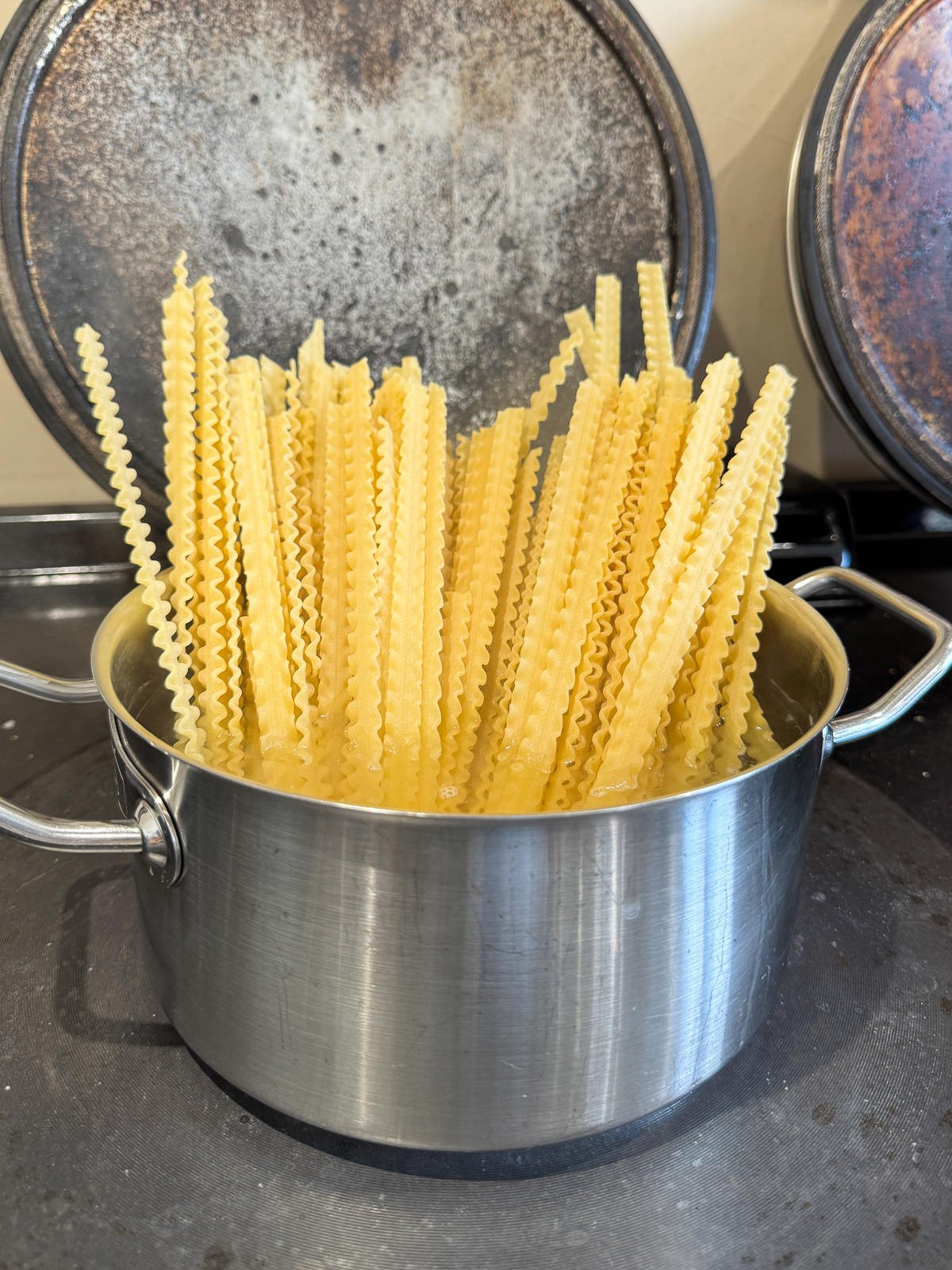 mafaldine pasta cooking in saucepan