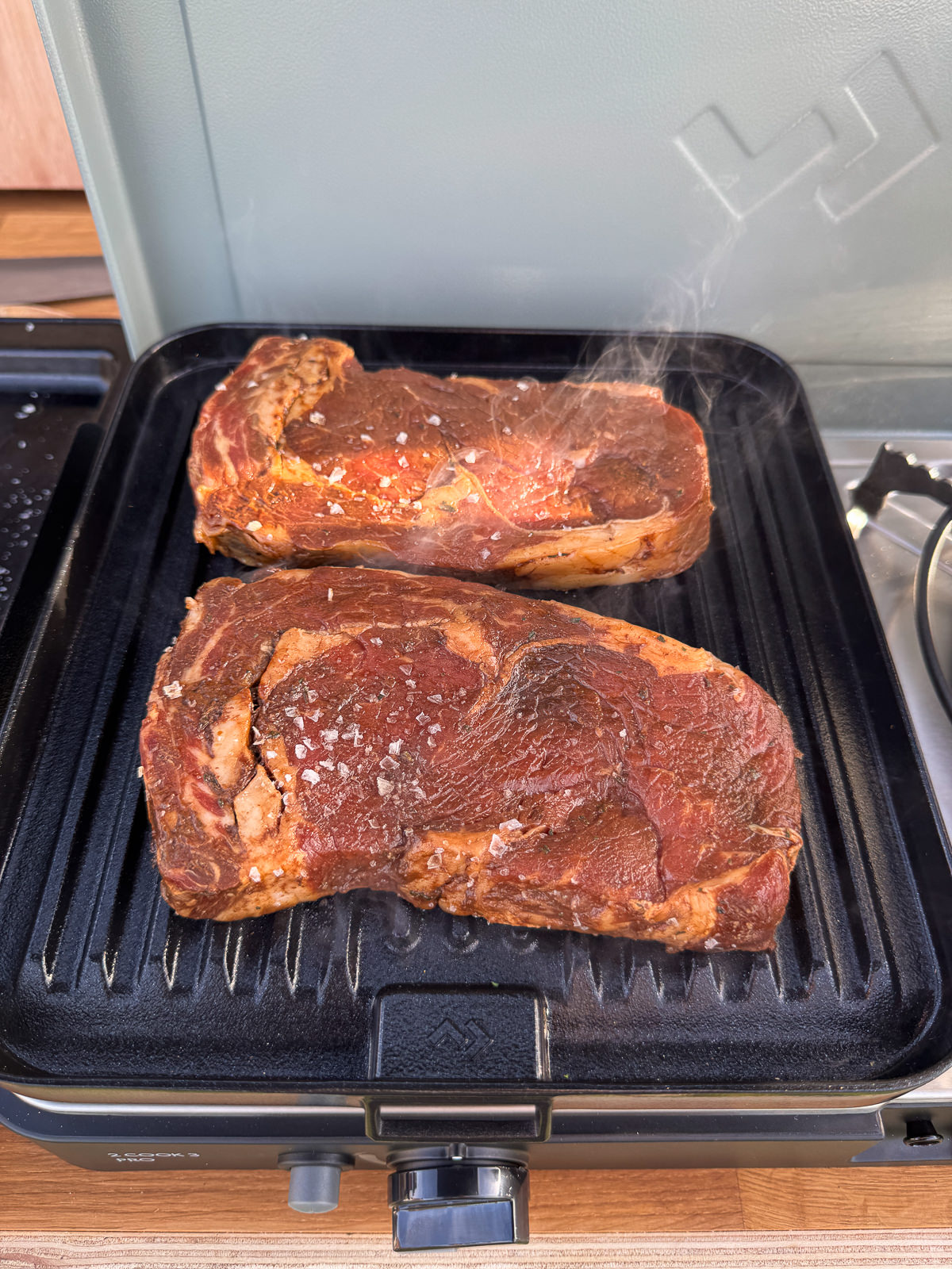 grilling steak on griddle