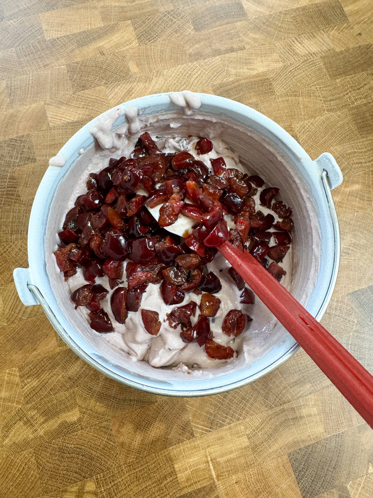 mixing cherry pieces into ice cream