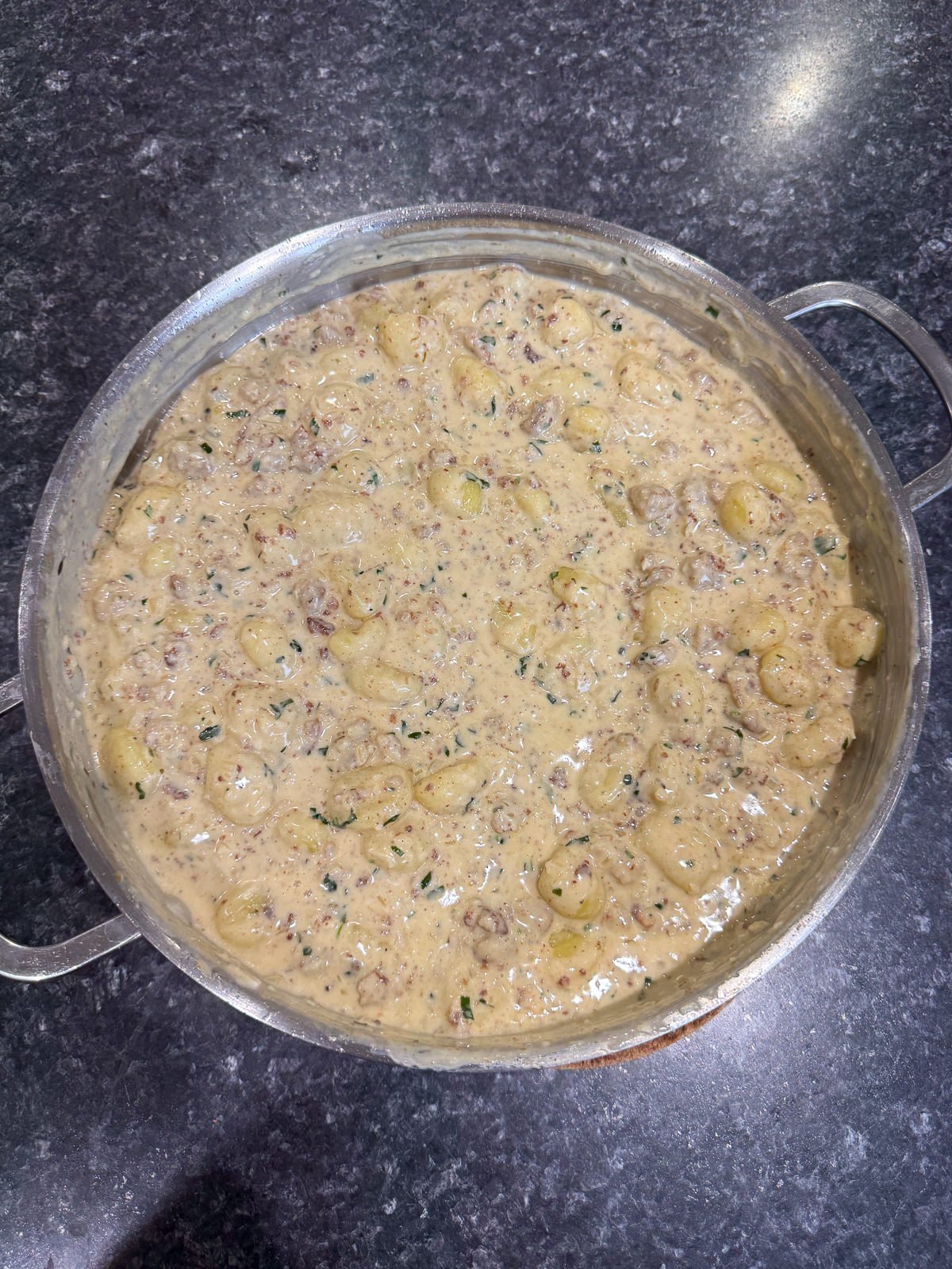 creamy garlic sausage gnocchi in pan