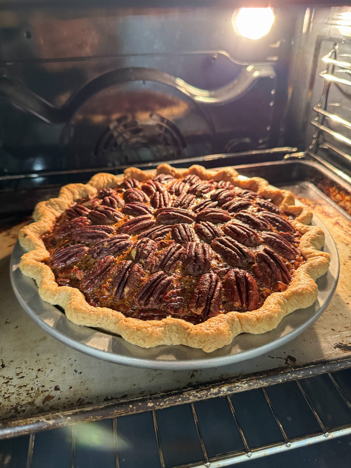 pecan pie baking in oven
