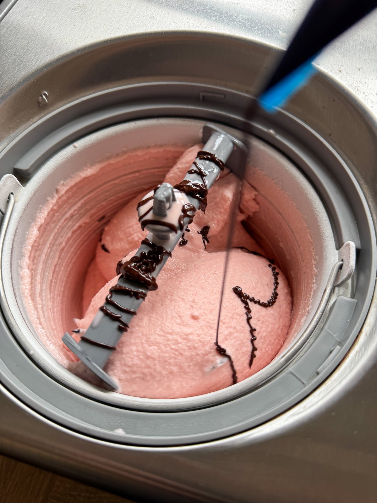 piping chocolate into churning ice cream
