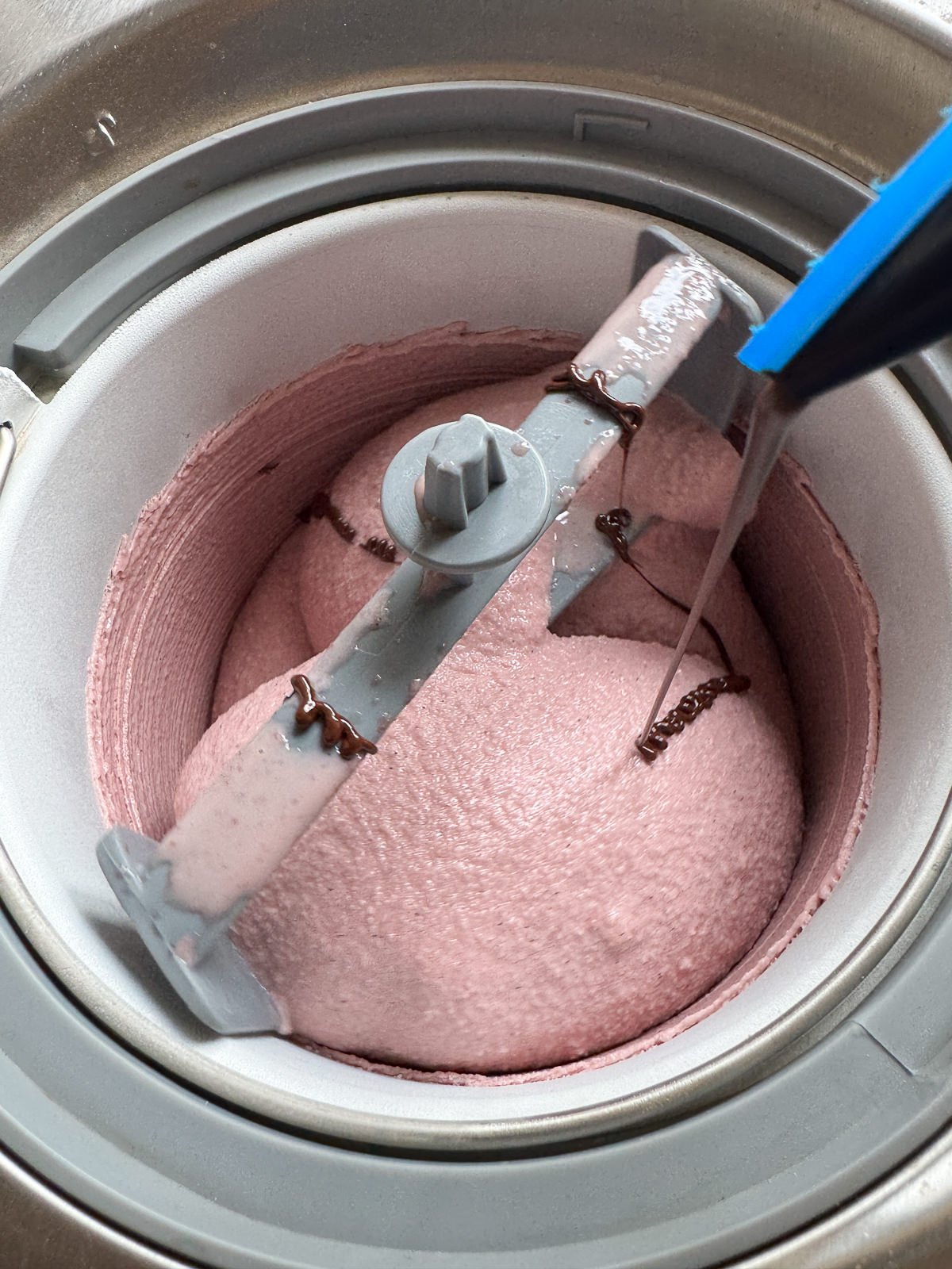 piping melted dark chocolate into churning ice cream
