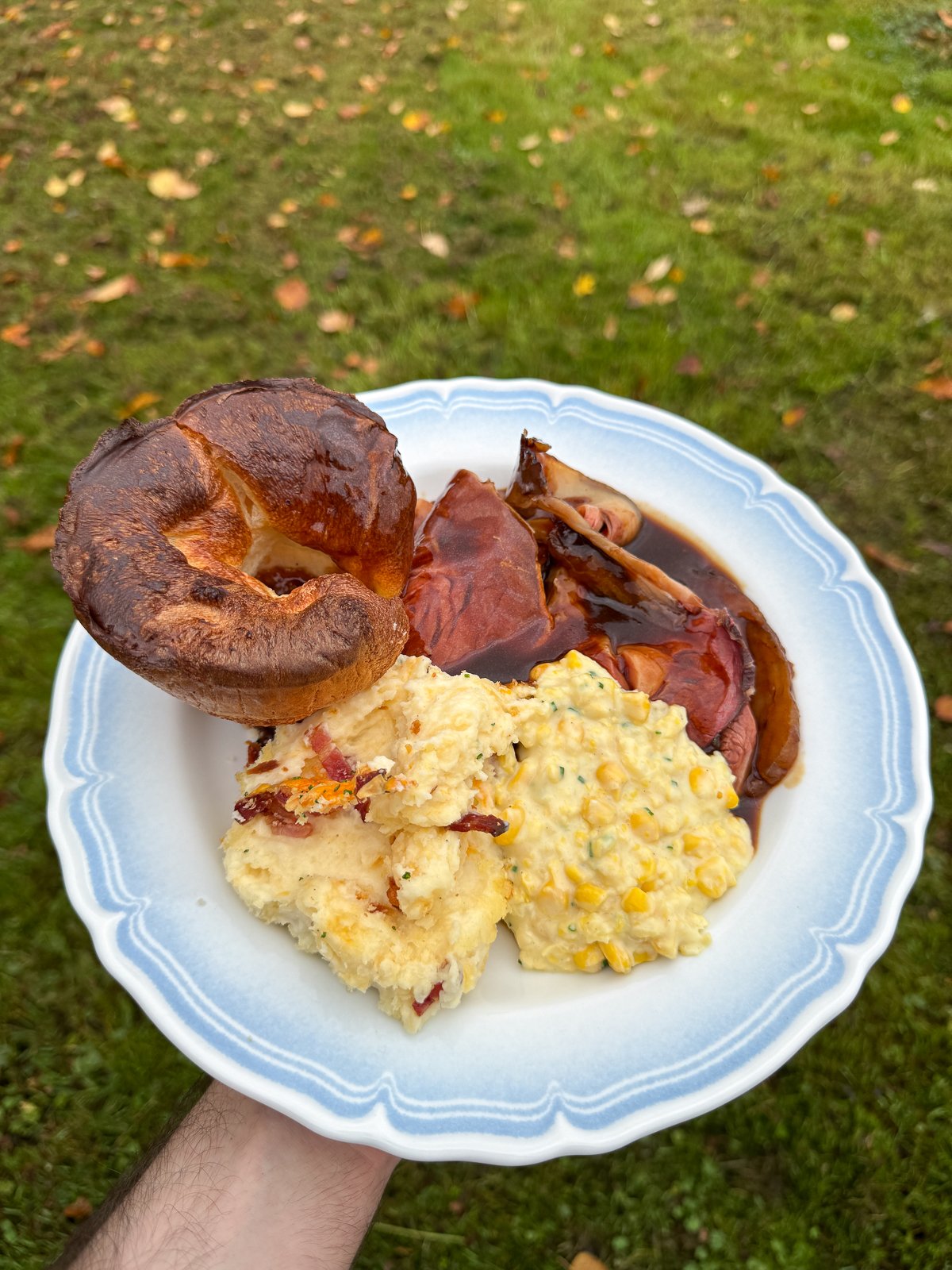plate of prime rib with thanksgiving side dishes