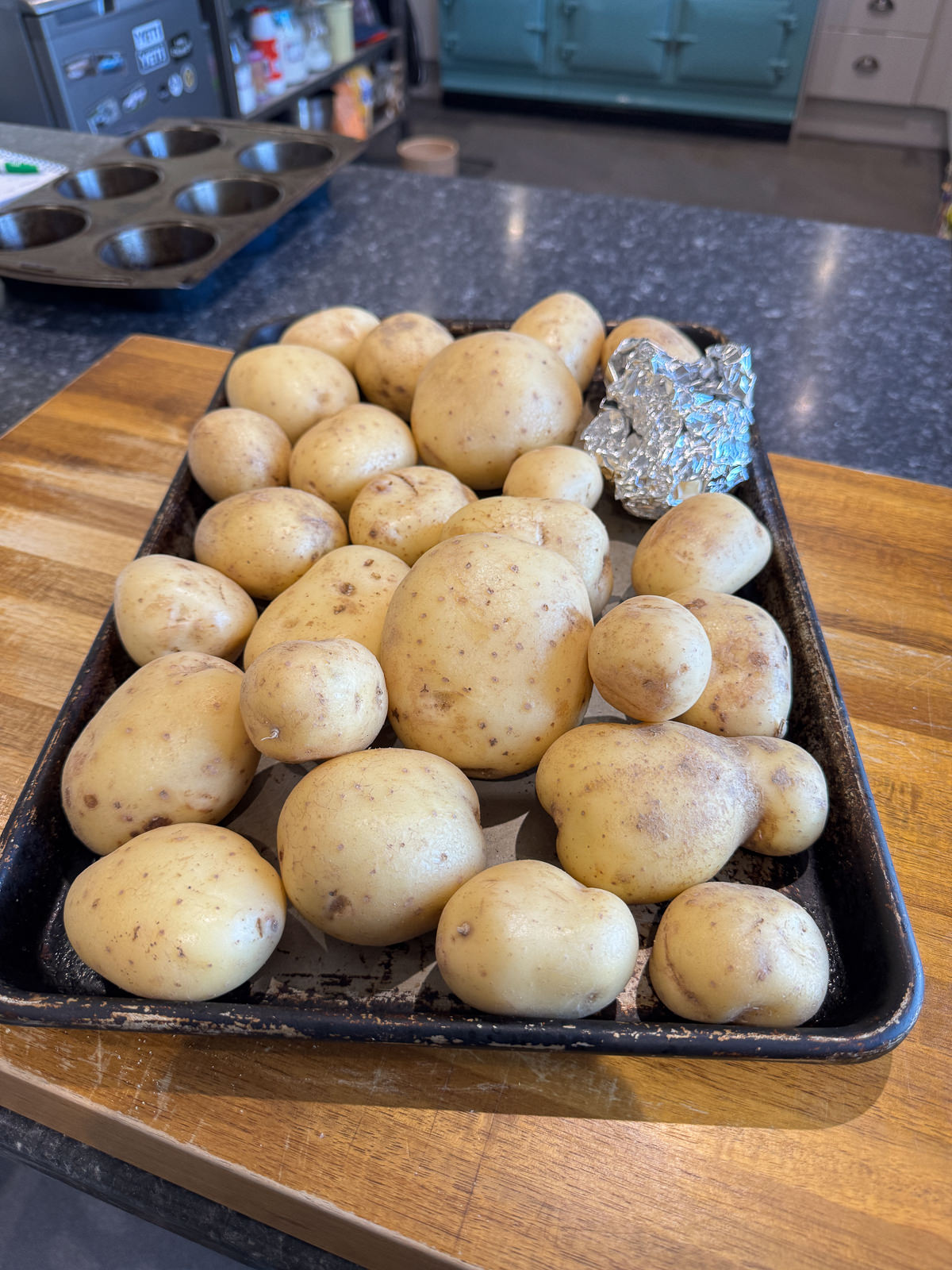 potatoes on baking tray to go in oven with garlic