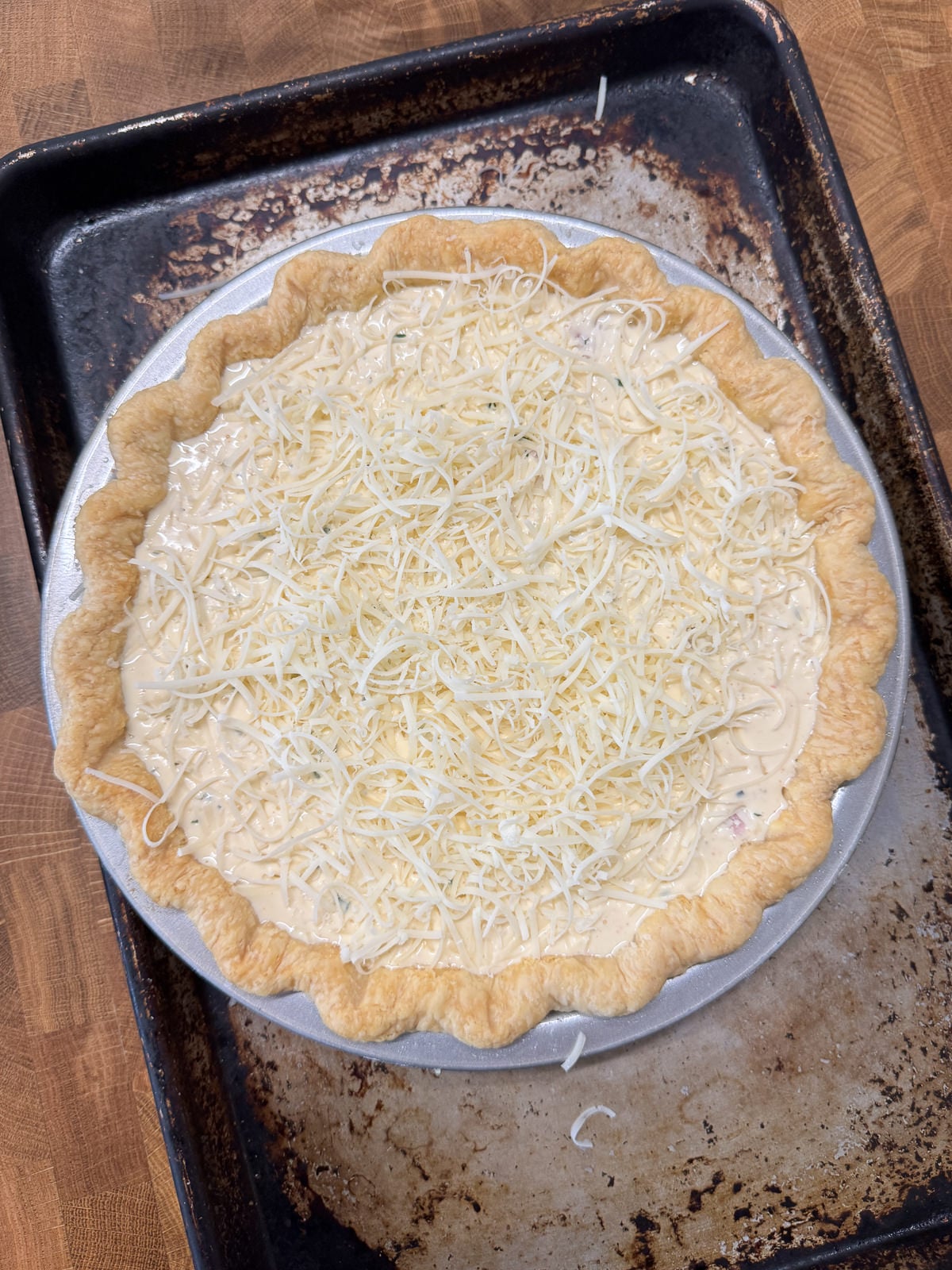 filled pie crust topped with cheese