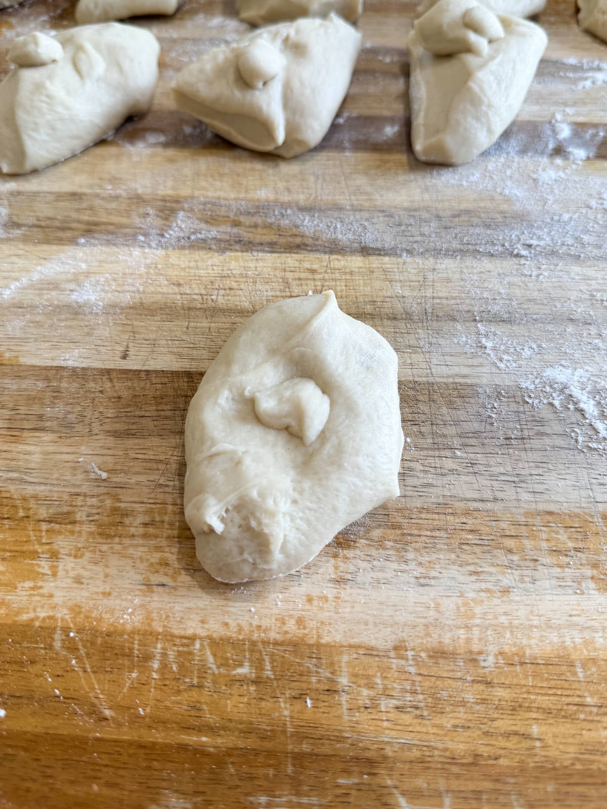 shaping dough into dinner rolls