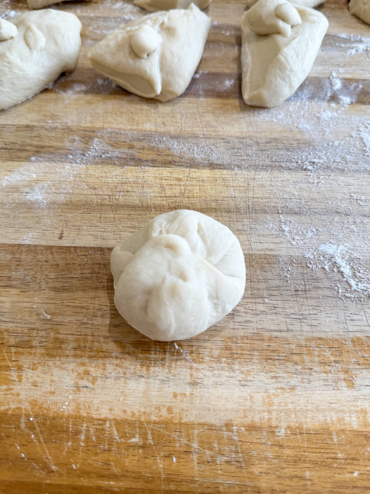 folding dough to form ball