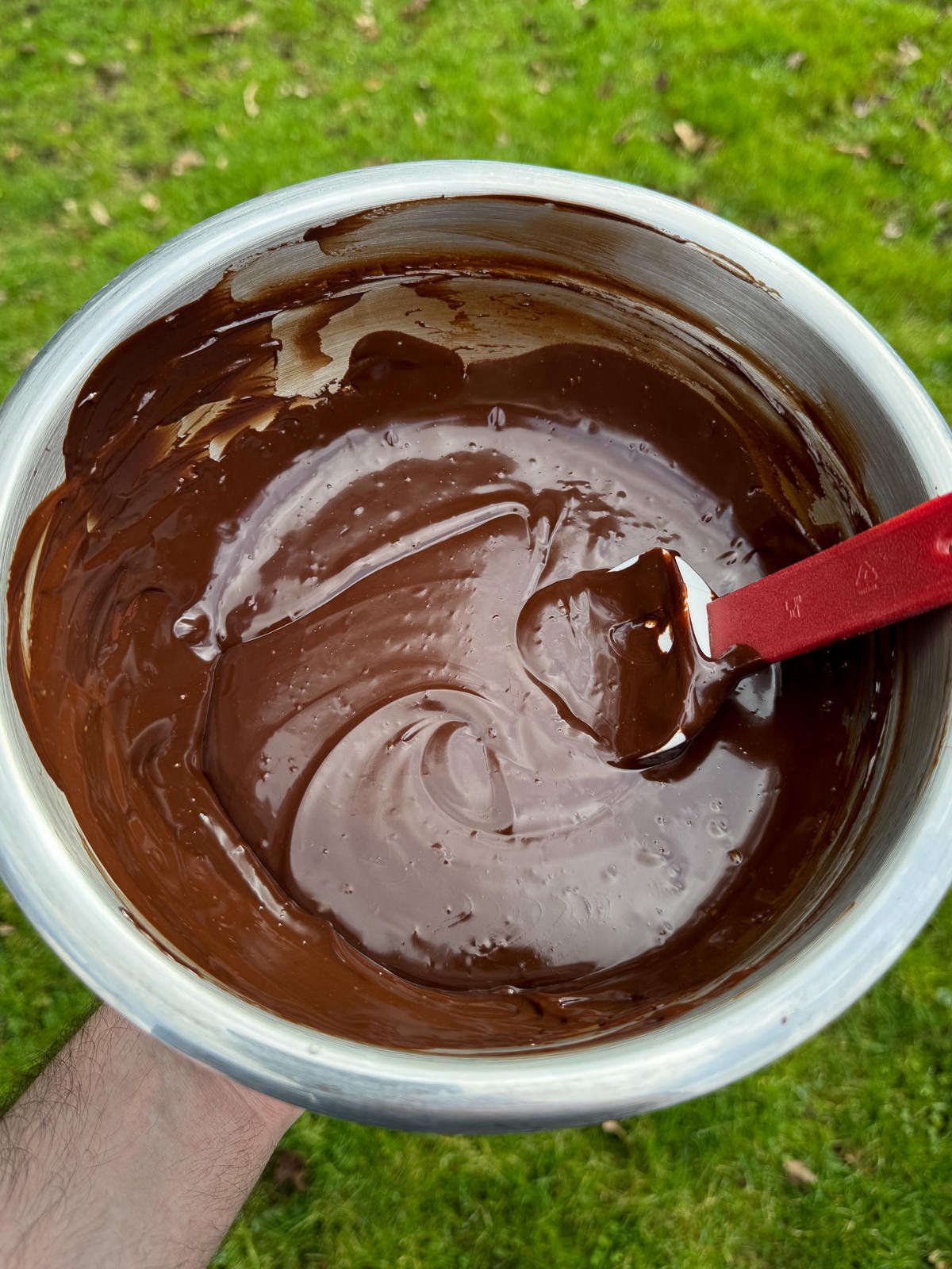 shiny chocolate ganache in mixing bowl