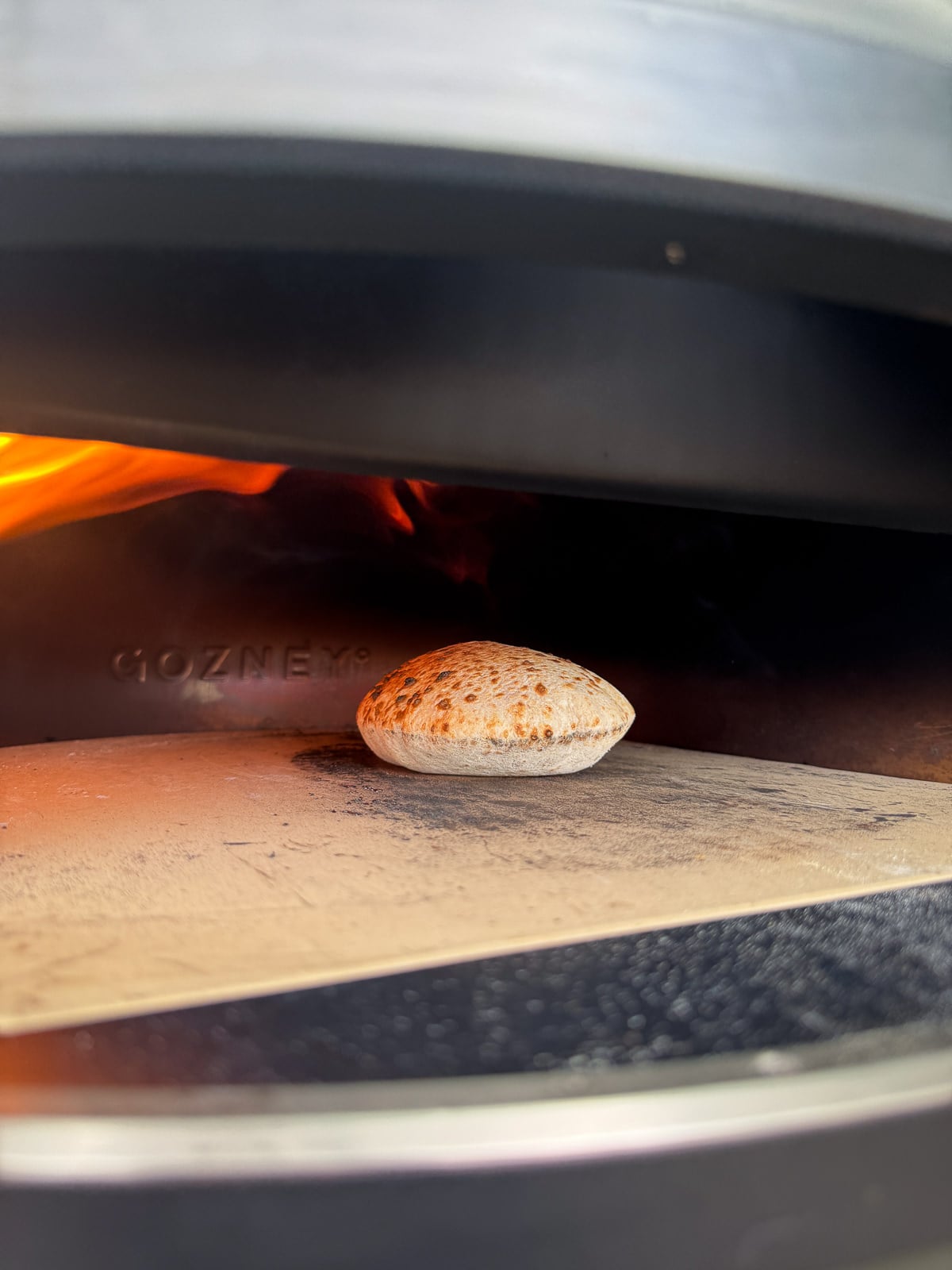 homemade pita baking in pizza oven