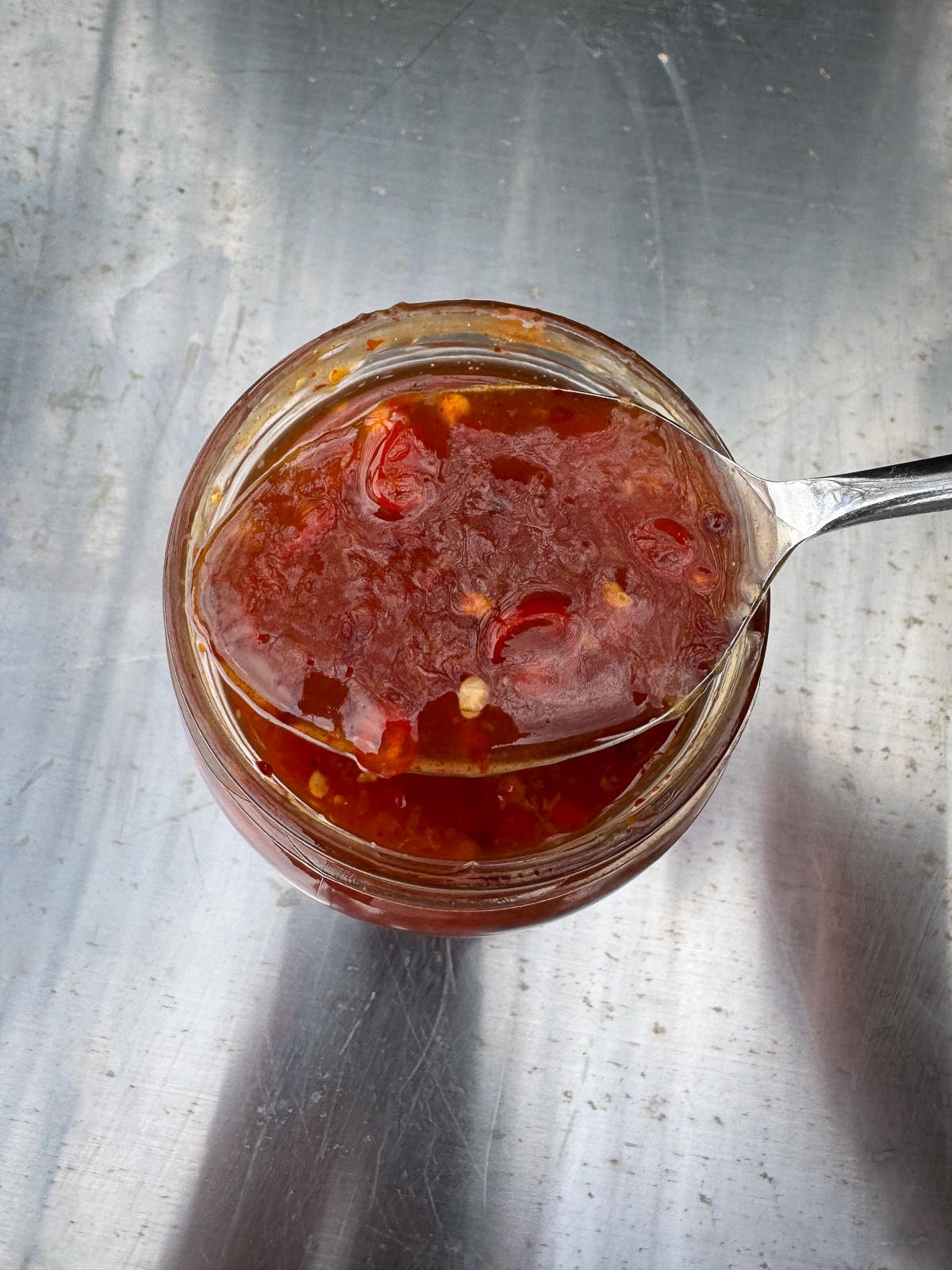 spoonful of homemade chilli sauce out of jar