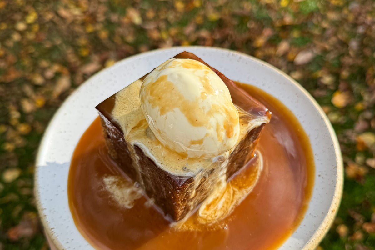 sticky toffee pudding with a scoop of vanilla ice cream