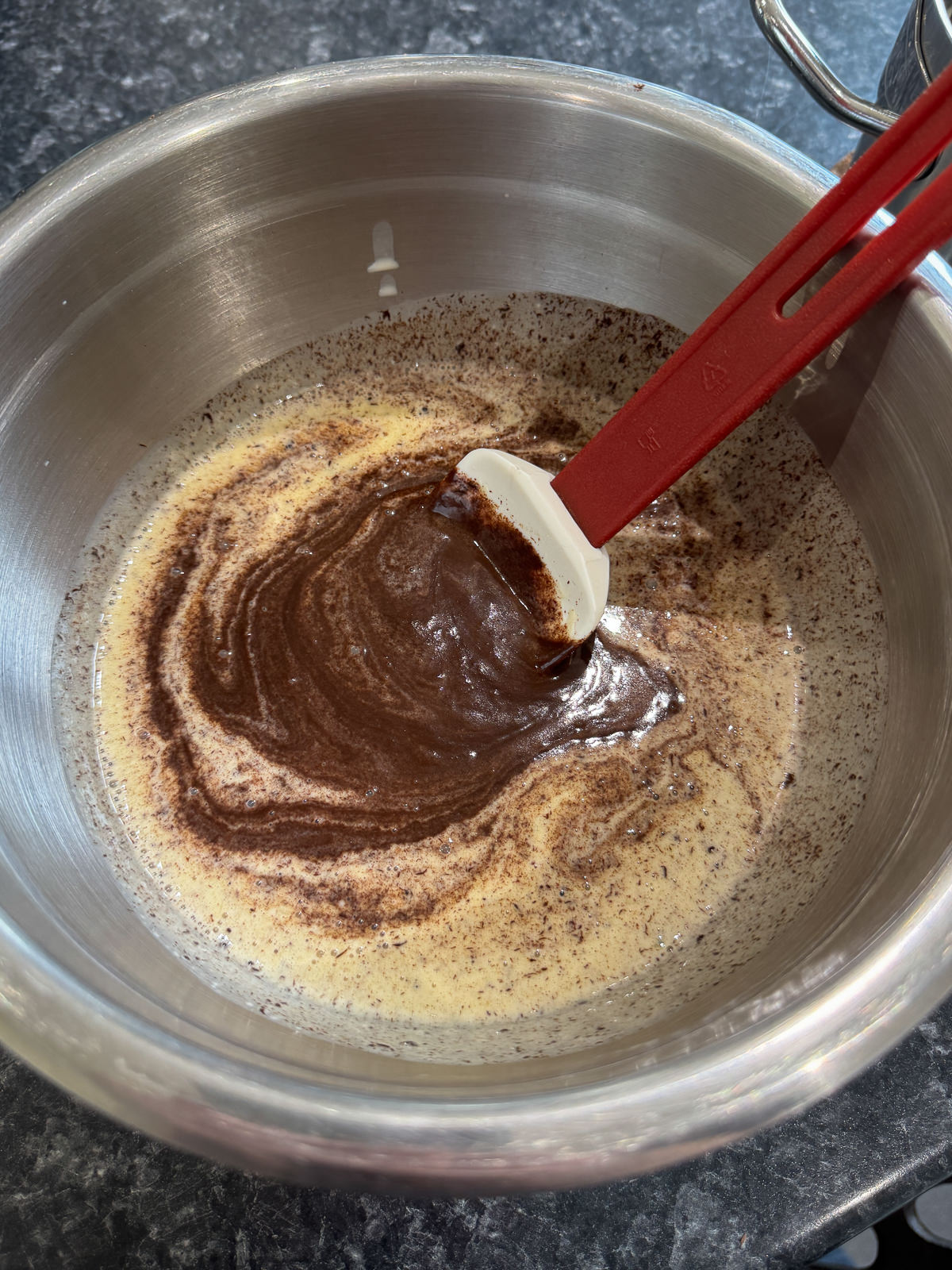 stirring chocolate ganache to emulsify