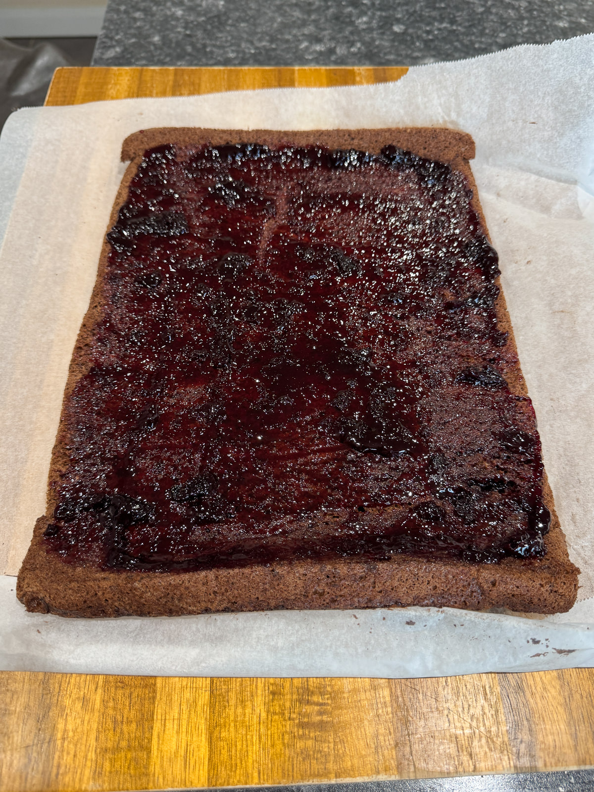 thin layer of cherry jam on sponge
