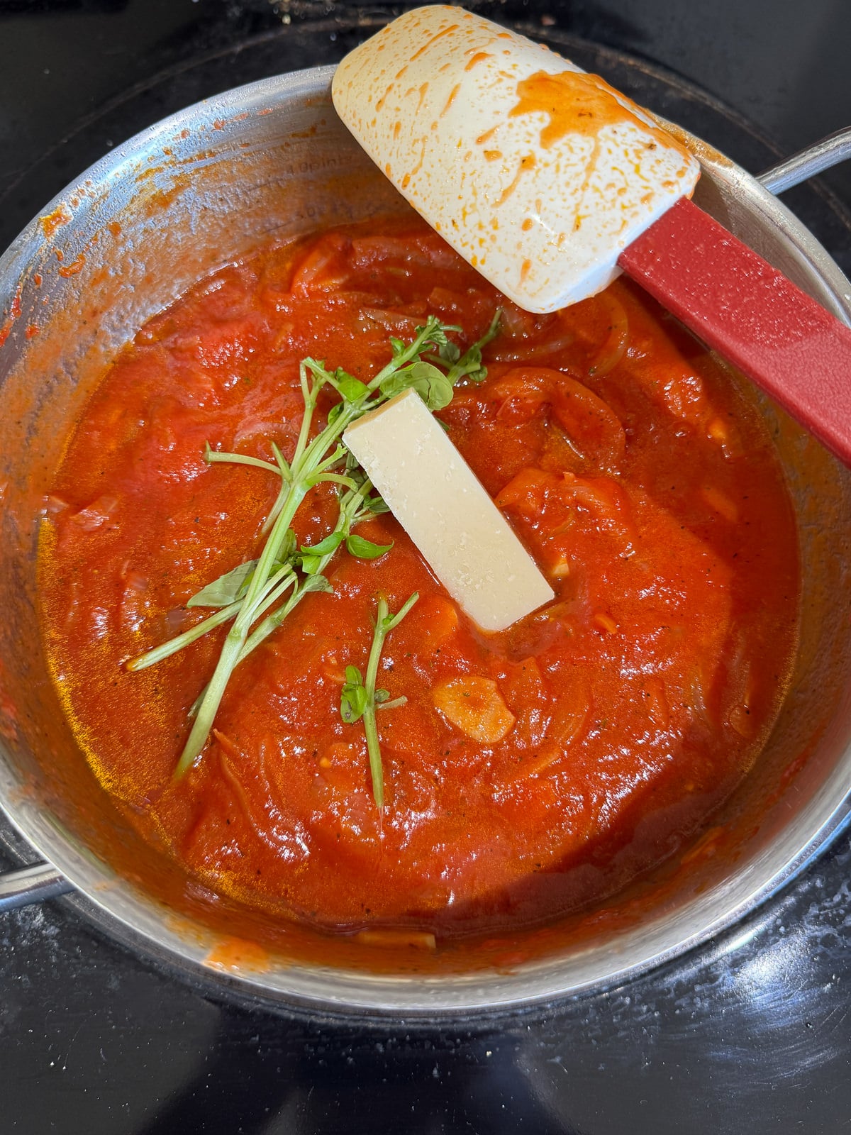 fresh basil stalks & parmesan rind added to sauce