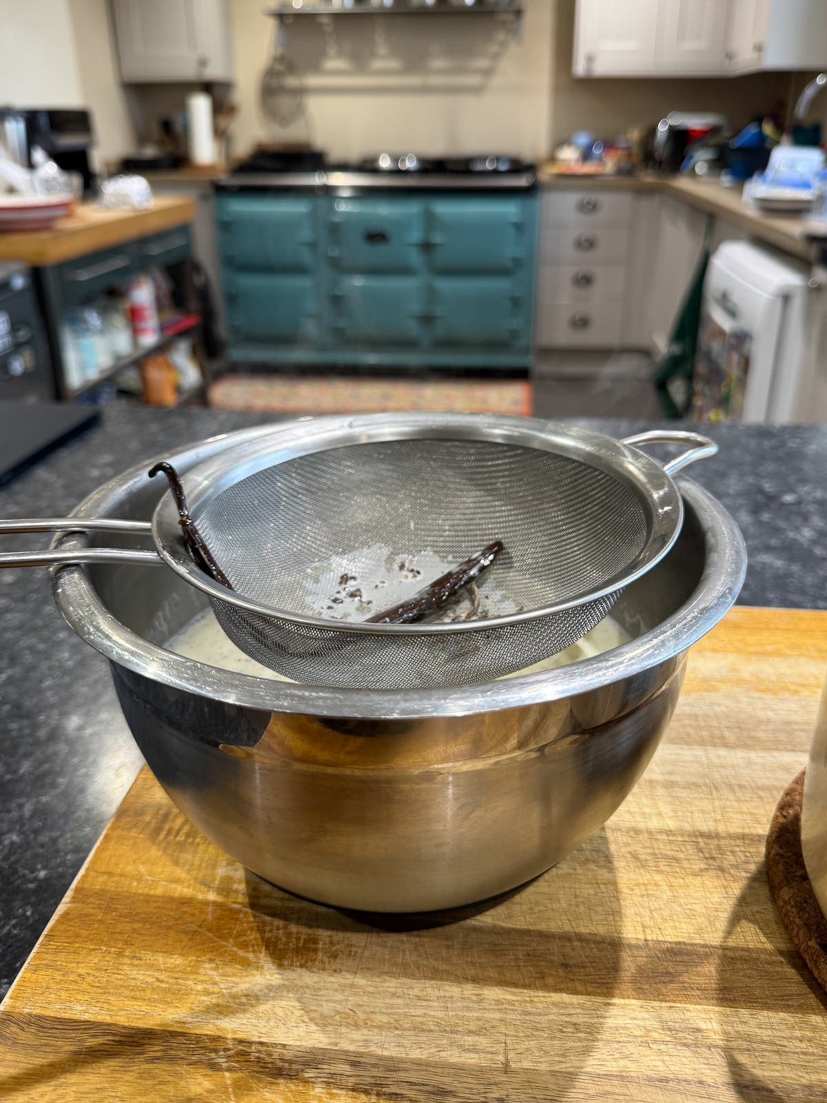vanilla cream passed through sieve into bowl over ice