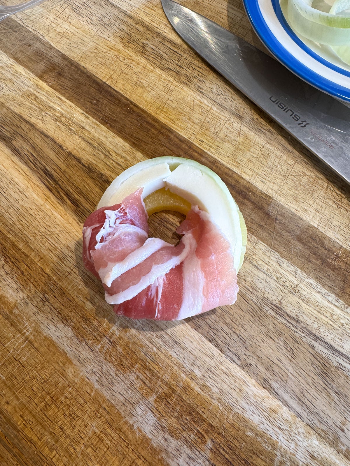 wrapping onion with streaky bacon