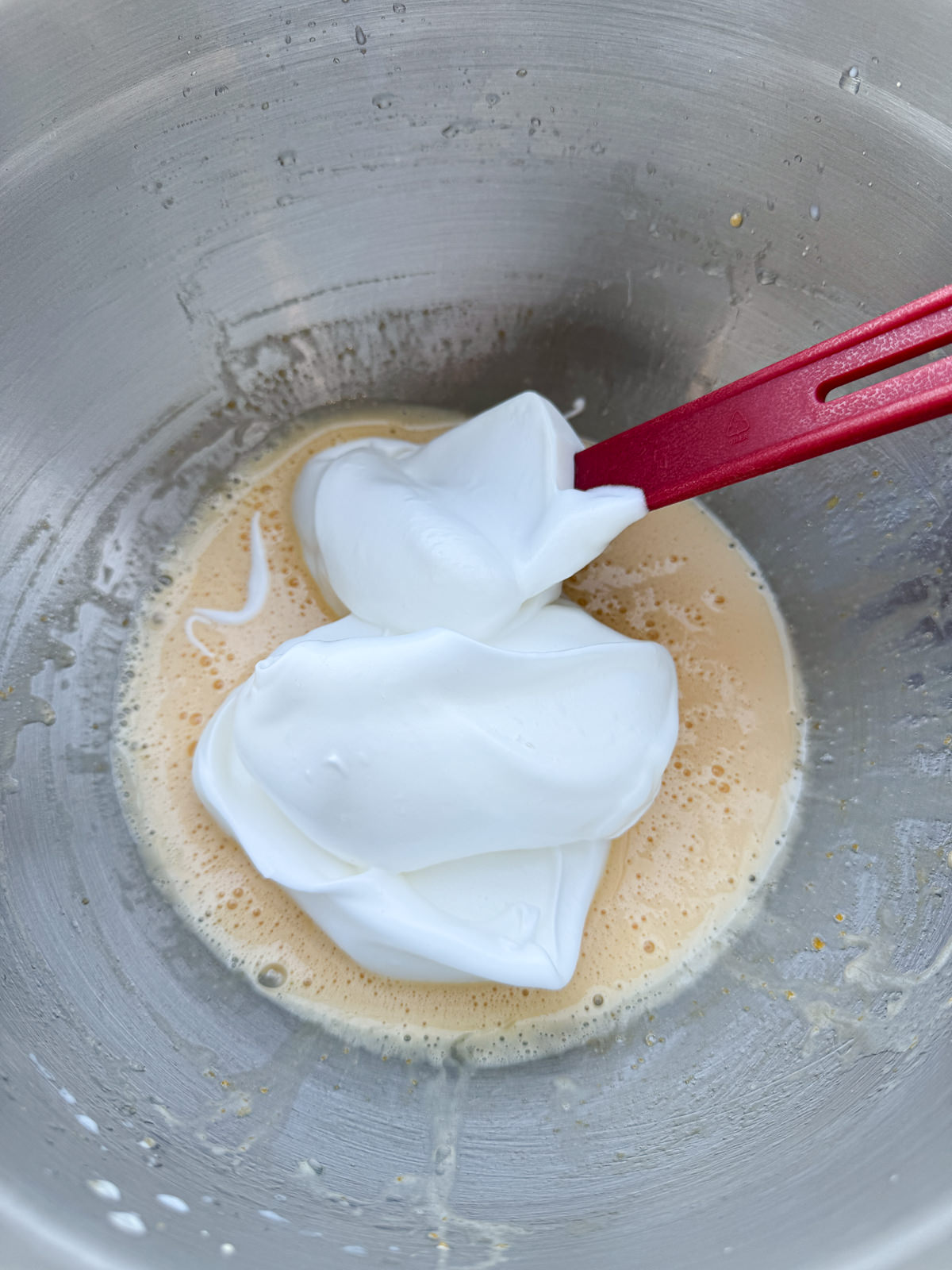 folding meringue into whipped yolks